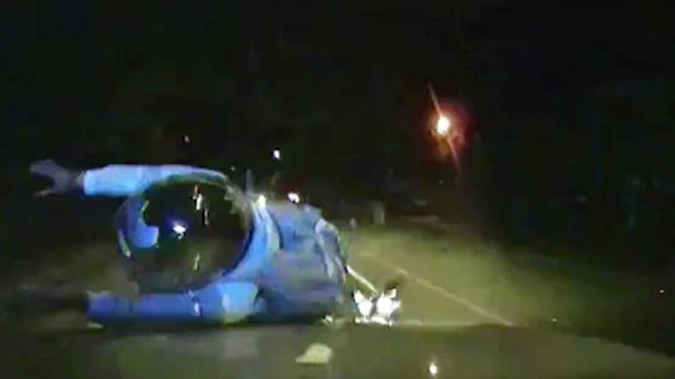 A screenshot of footage showing London police cars colliding with people riding mopeds.