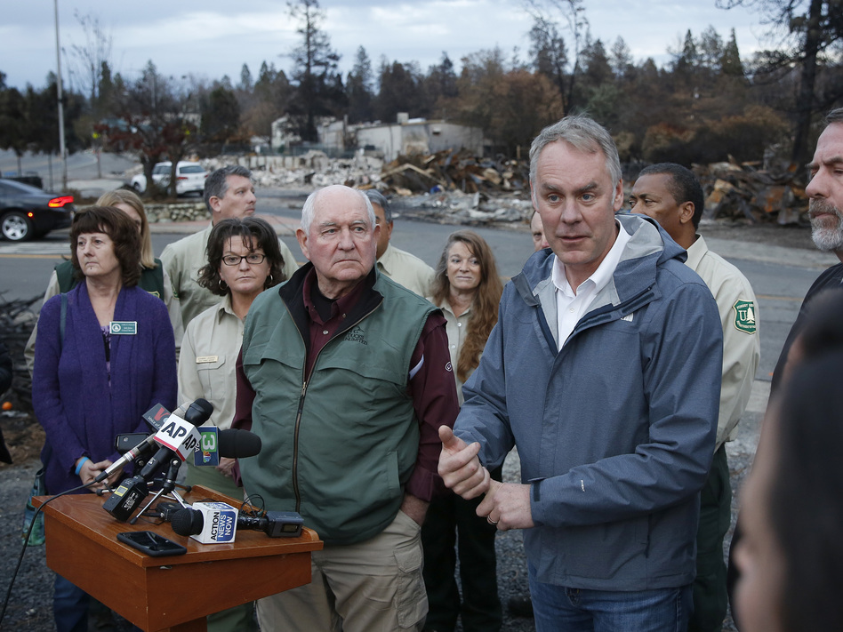 Interior Secretary Ryan Zinke, right, answers a reporters question after touring fire ravaged Paradise, Calif. with Agriculture Secretary Sonny Perdue, center. The pair advocated more aggressive forest management policies to mitigate damage from future wildfires. (Rich Pedroncelli/AP)