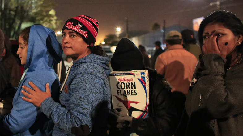 Central American migrants wait in line in hopes of receiving donated food and hygiene supplies, outside of a sports complex serving as a shelter for more than 5,000 Central American migrants, in Tijuana, Mexico. (Rebecca Blackwell/AP)