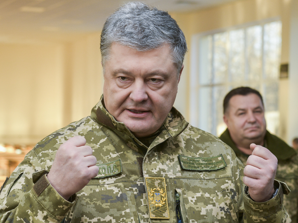 Ukrainian President Petro Poroshenko speaks to soldiers during a visit to a military base in Chernihiv region, Ukraine, on Wednesday. Russia and Ukraine traded blame after Russian border guards on Sunday opened fire on three Ukrainian navy vessels and eventually seized them and their crews. The incident put the two countries on a war footing and raised international concern. (Mykola Lazarenko/Presidential Press Service via AP)