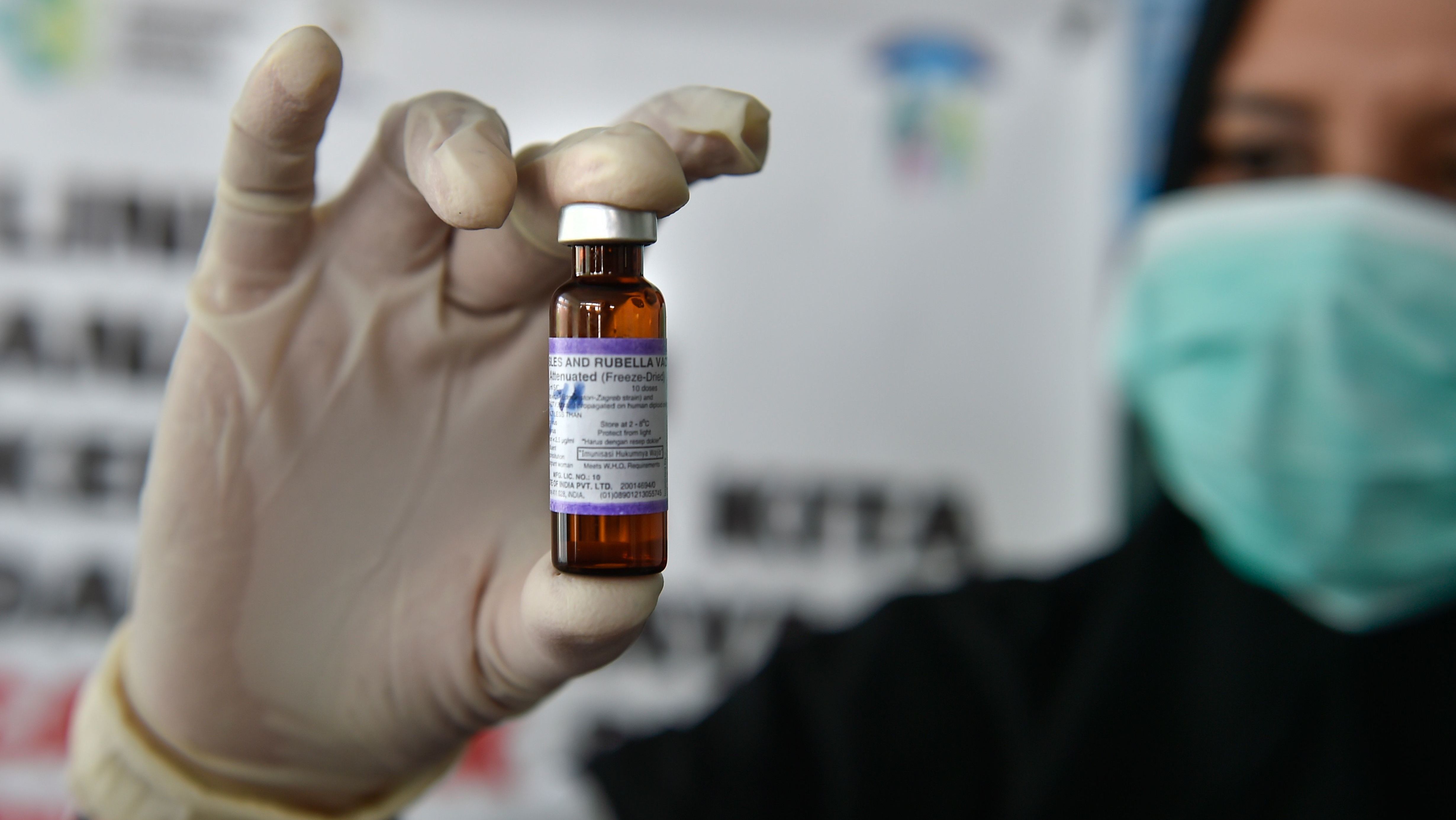 A medical worker holds a measles-rubella vaccine at a health station in Banda Aceh, Indonesia. (AFP/Getty Images)