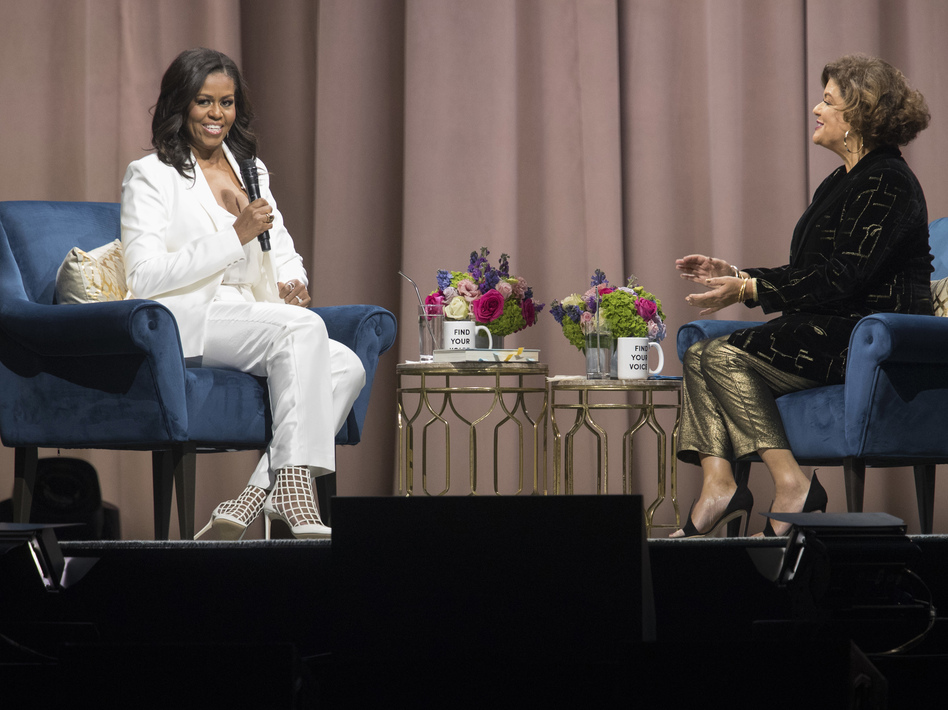 Michelle Obama (left) talks with poet Elizabeth Alexander during an event for the former first lady's memoir at Barclays Center in Brooklyn, N.Y., on Saturday. (Mary Altaffer/AP)