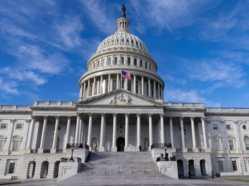 The U.S. flag flies at half-staff in honor of former President George H.W. Bush outside the Capitol in Washington, D.C., Monday. Top Hill leaders planned on a stopgap funding bill to avoid a partial shutdown at the end of the week.