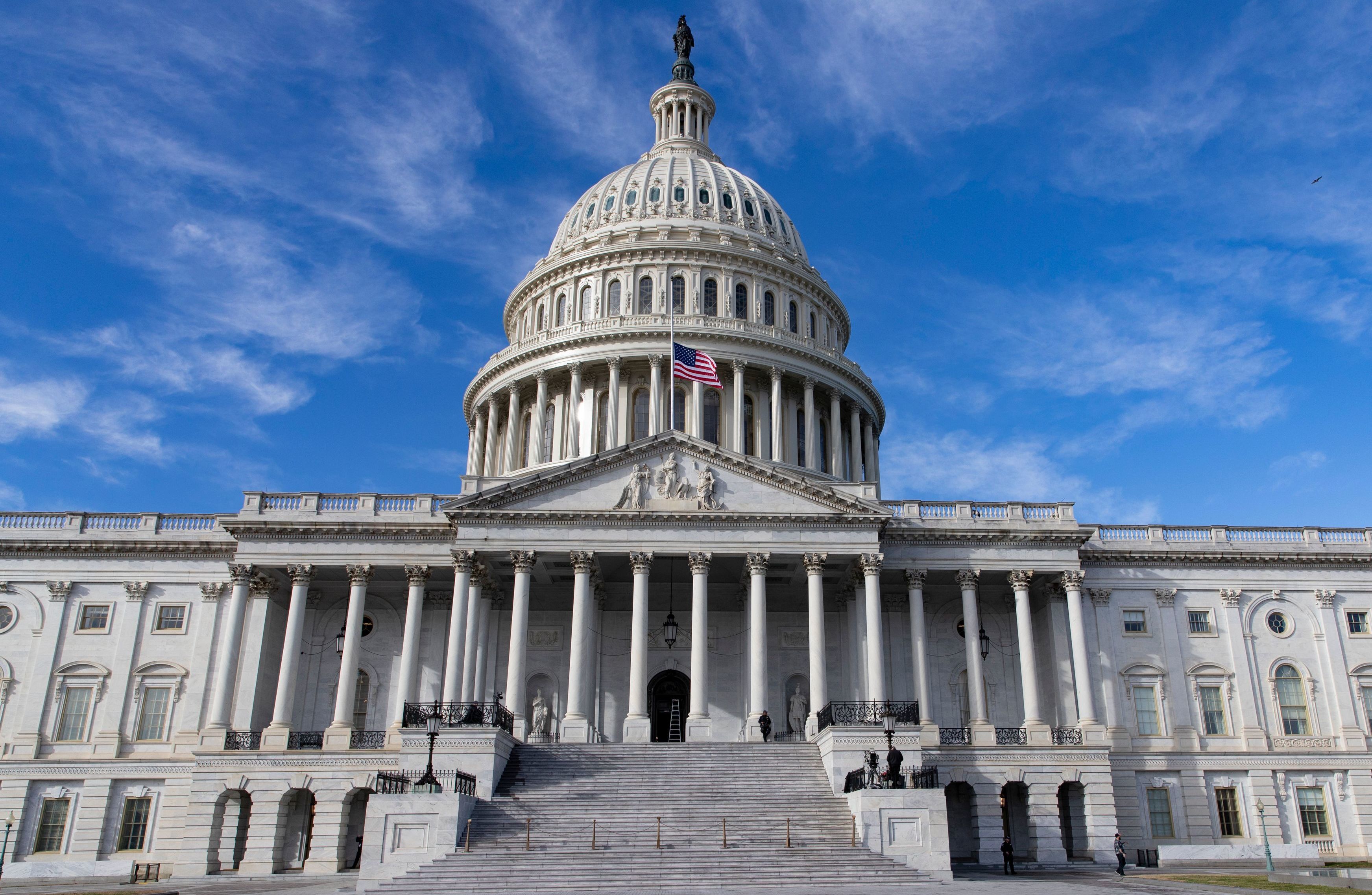 The U.S. flag flies at half-staff in honor of former President George H.W. Bush outside the Capitol in Washington, D.C., Monday. Top Hill leaders planned on a stopgap funding bill to avoid a partial shutdown at the end of the week. (AFP/Getty Images)