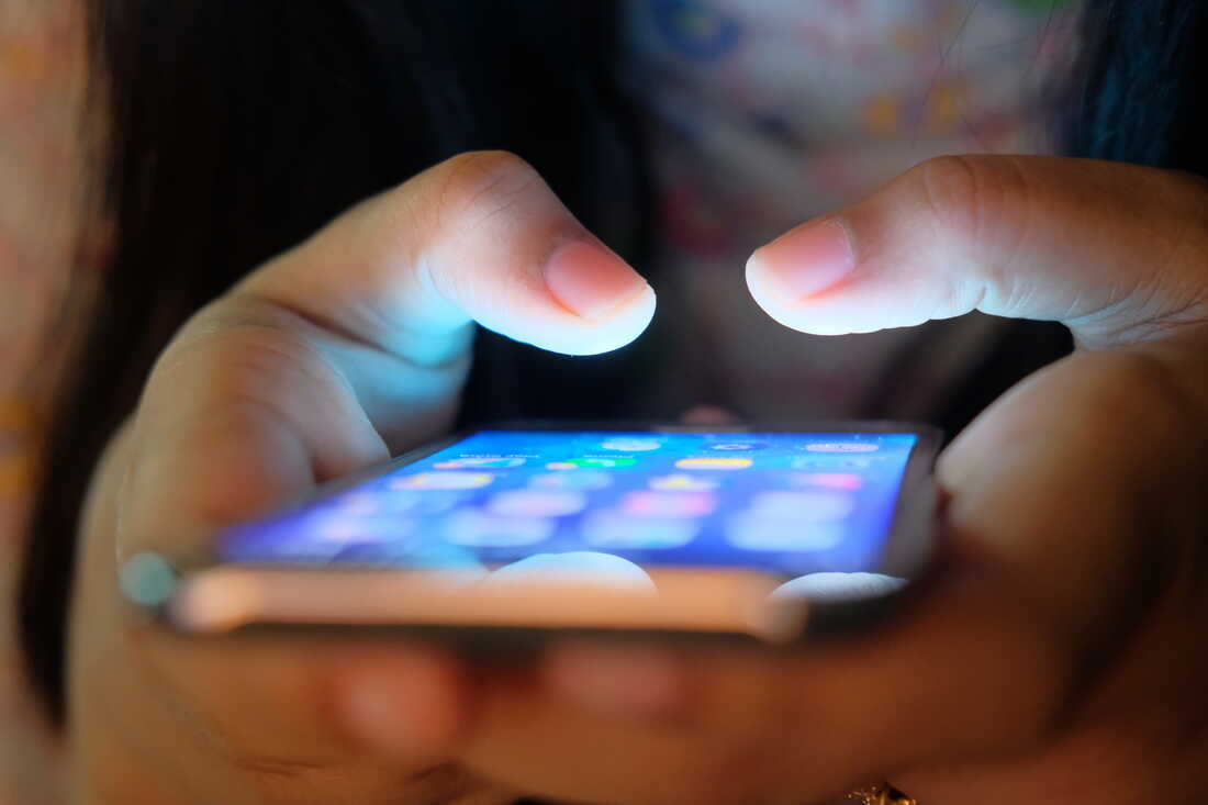 A user of social media application software on a smartphone.