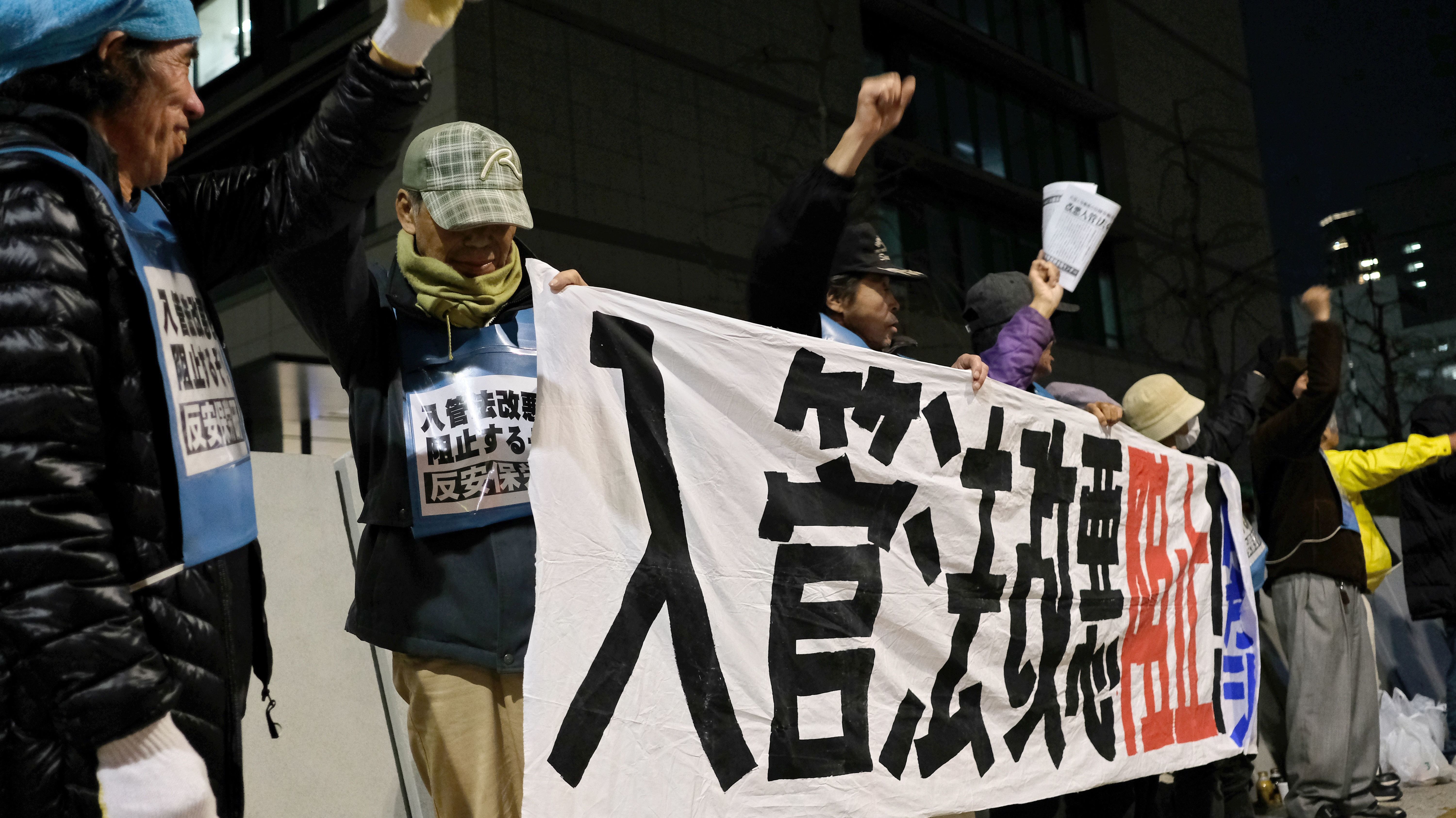 In front of Japan's parliament on Friday, people stage a rally against the bill to allow more foreign workers into the country. (AFP/Getty Images)