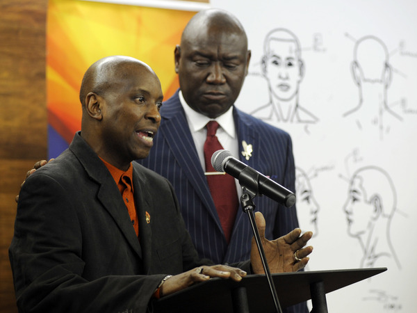 Flanked by attorney Ben Crump, Emantic Bradford Sr. discusses the results of a forensic examination on his son Emantic "EJ" Bradford Jr., who was fatally shot by police after a shooting in a shopping mall on Thanksgiving Day, after being mistaken for a suspect.