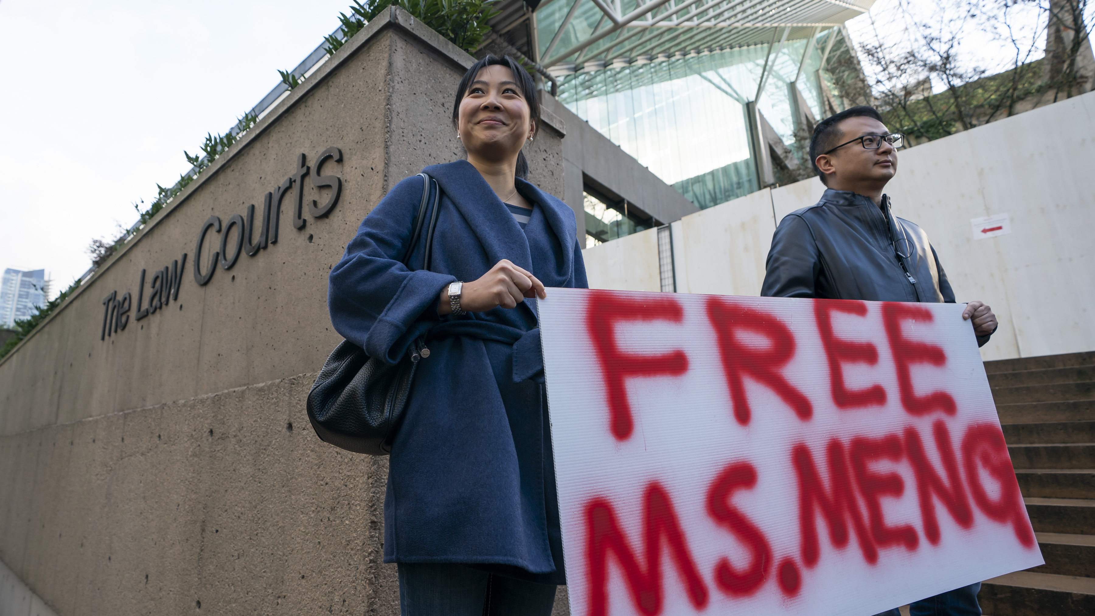 Supporters Ada Yu and Wade Meng (no relation) stand outside the British Columbia Supreme Court on Monday before the bail hearing for Huawei Technologies CFO Meng Wanzhou in Vancouver.