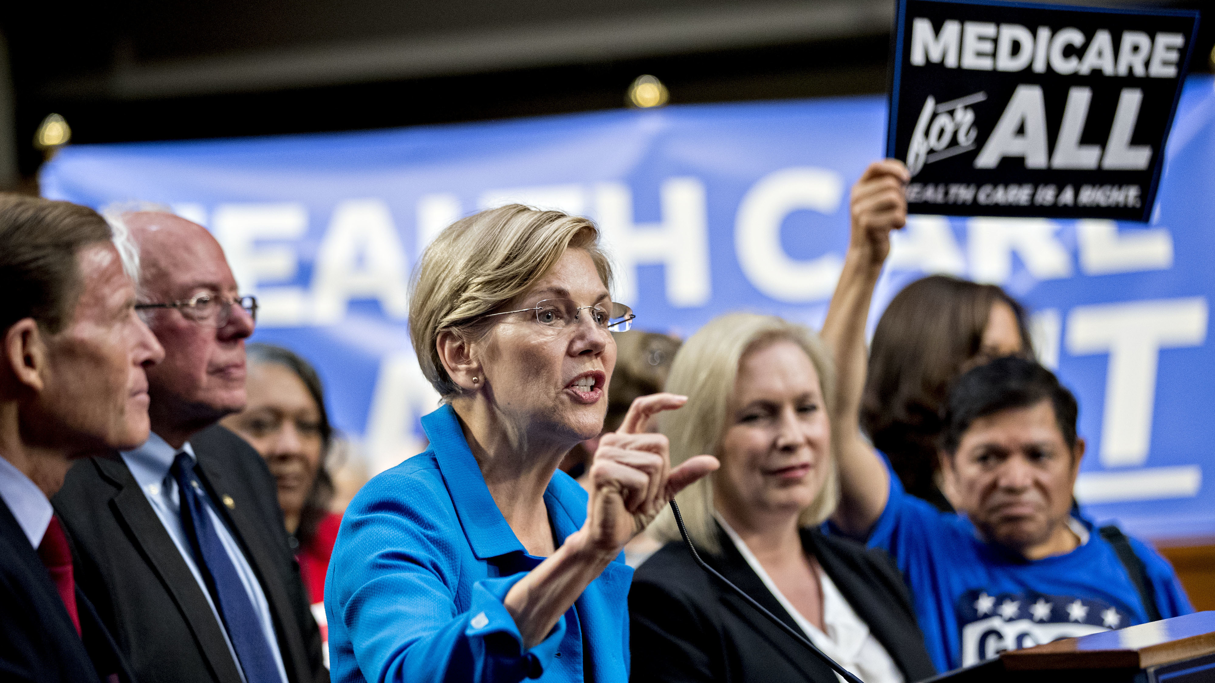 Sen. Elizabeth Warren, a Democrat from Massachusetts (center), is just one of several potential 2020 presidential candidates who came out in support of Sanders' Medicare for All proposal in 2017. (Bloomberg via Getty Images)