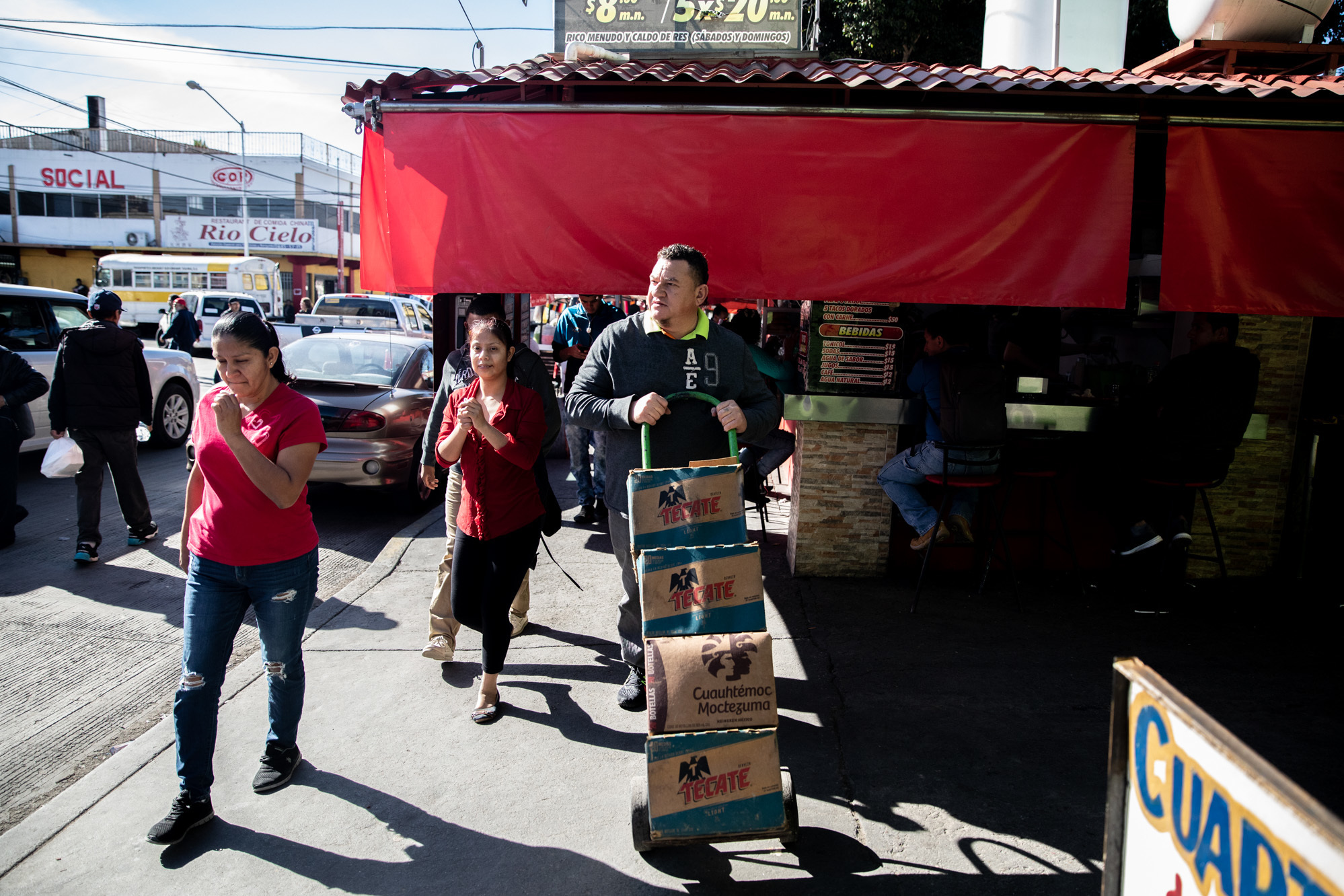 José Aguilar heads to the store on a supply run in Tijuana, Mexico. His restaurant Honduras 504 has become a community center for Honduran legal residents and unauthorized migrants alike. (Tomás Ayuso for NPR)