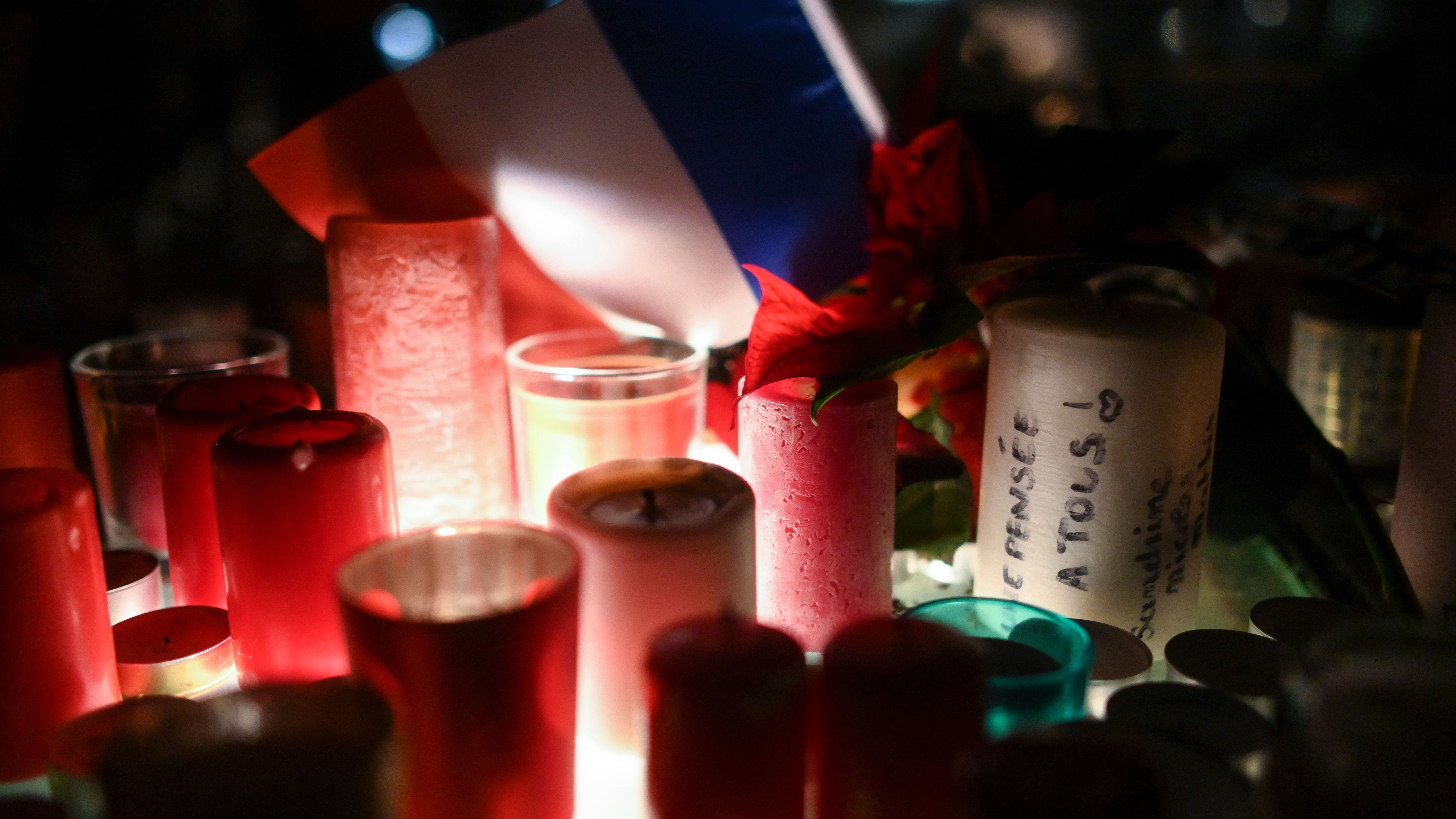 During a memorial vigil on Thursday, candles mark the scene of the Strasbourg, France, Christmas market shooting.
