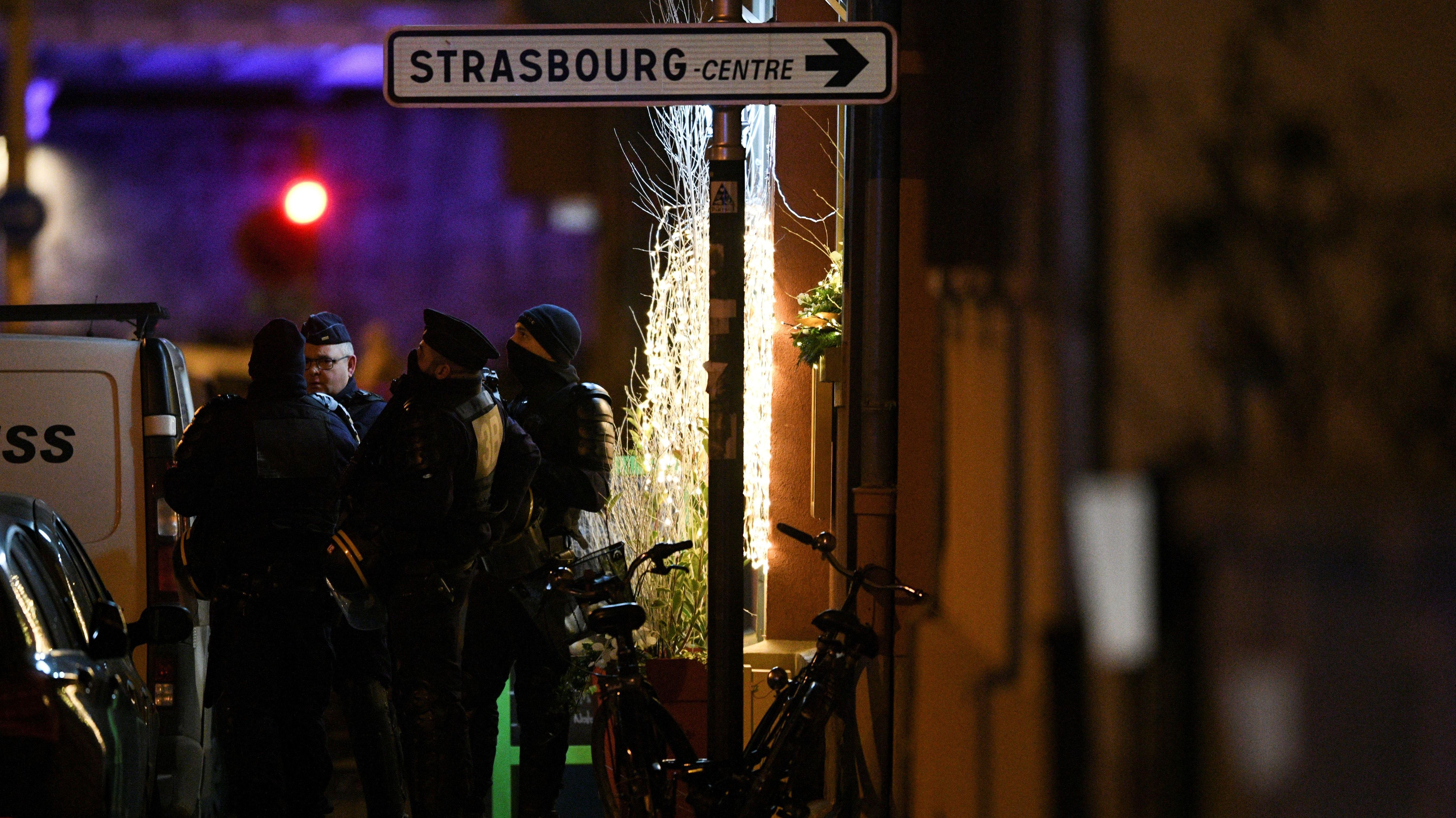 Police officers stand near the place where Cherif Chekatt, the alleged gunman who had been a fugitive since allegedly killing three people at a popular Christmas market in Strasbourg, France, was shot dead by police on Thursday.