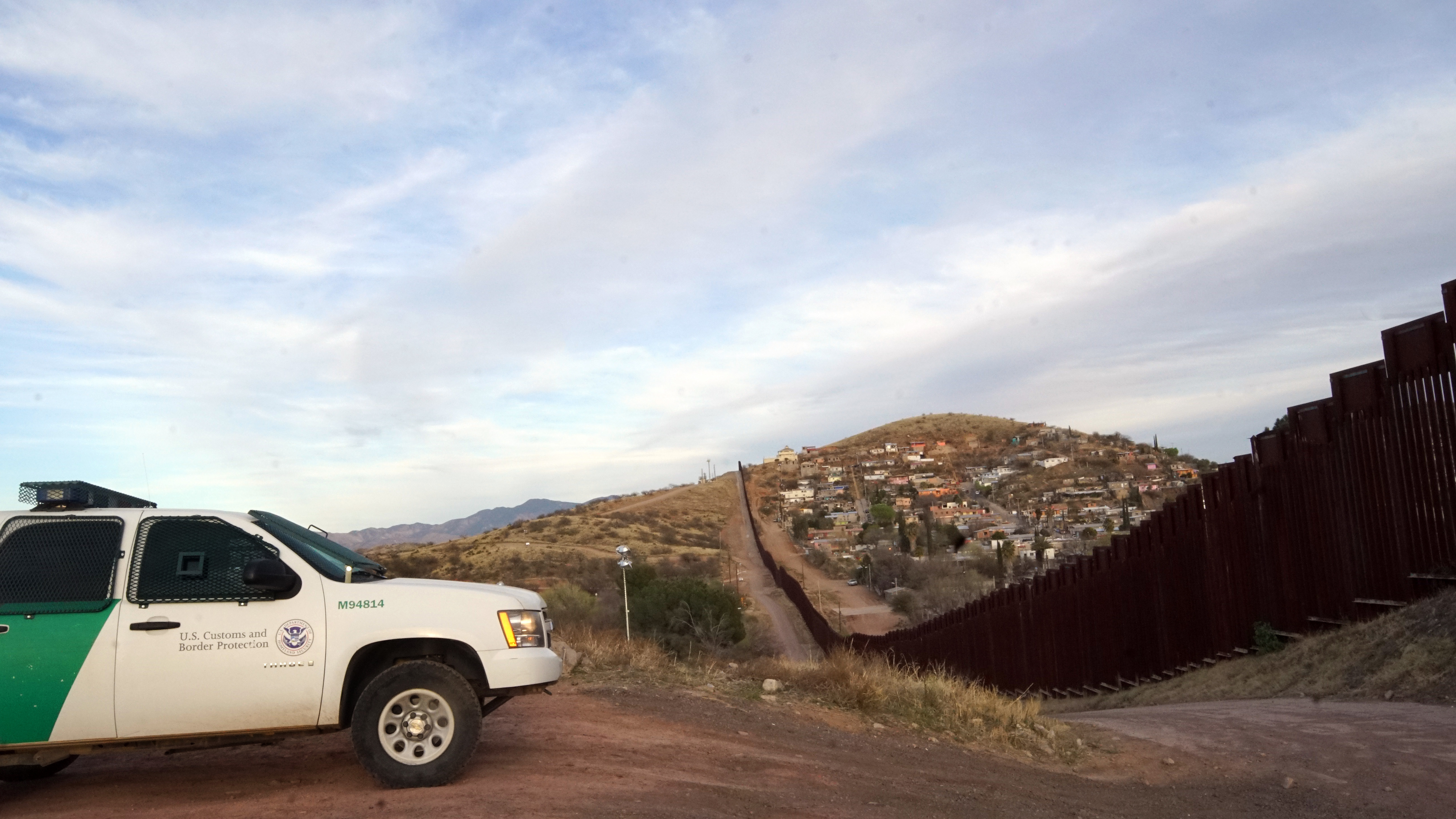 U.S. Border Patrol next to the the border wall dividing Nogales, Ariz., and Nogales Mexico. (Barcroft Media via Getty Images)