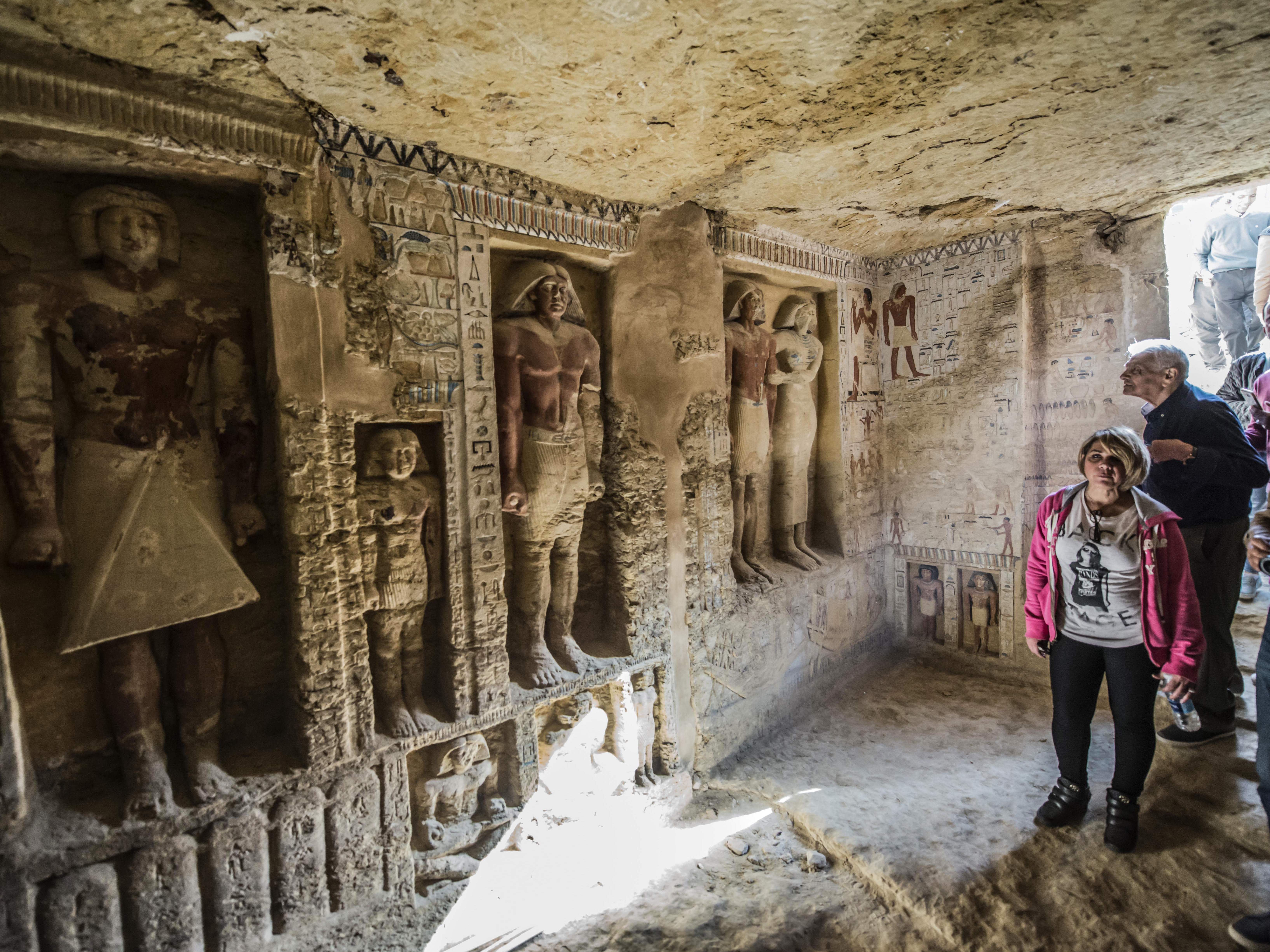 Visitors enter a newly-discovered Egyptian tomb at the Saqqara necropolis on Saturday. (AFP/Getty Images)