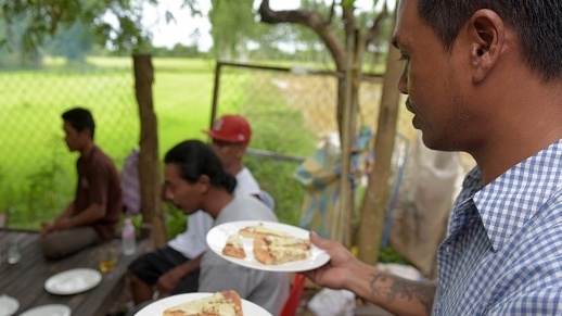 Nheb Thai, a Cambodian refugee who was deported from the U.S., serves a meal to other deportees in Battambang last year. Cambodia has taken in 566 deportees since inking a 2002 pact with the U.S. that opened the door for hundreds with criminal records to be repatriated. (AFP/Getty Images)