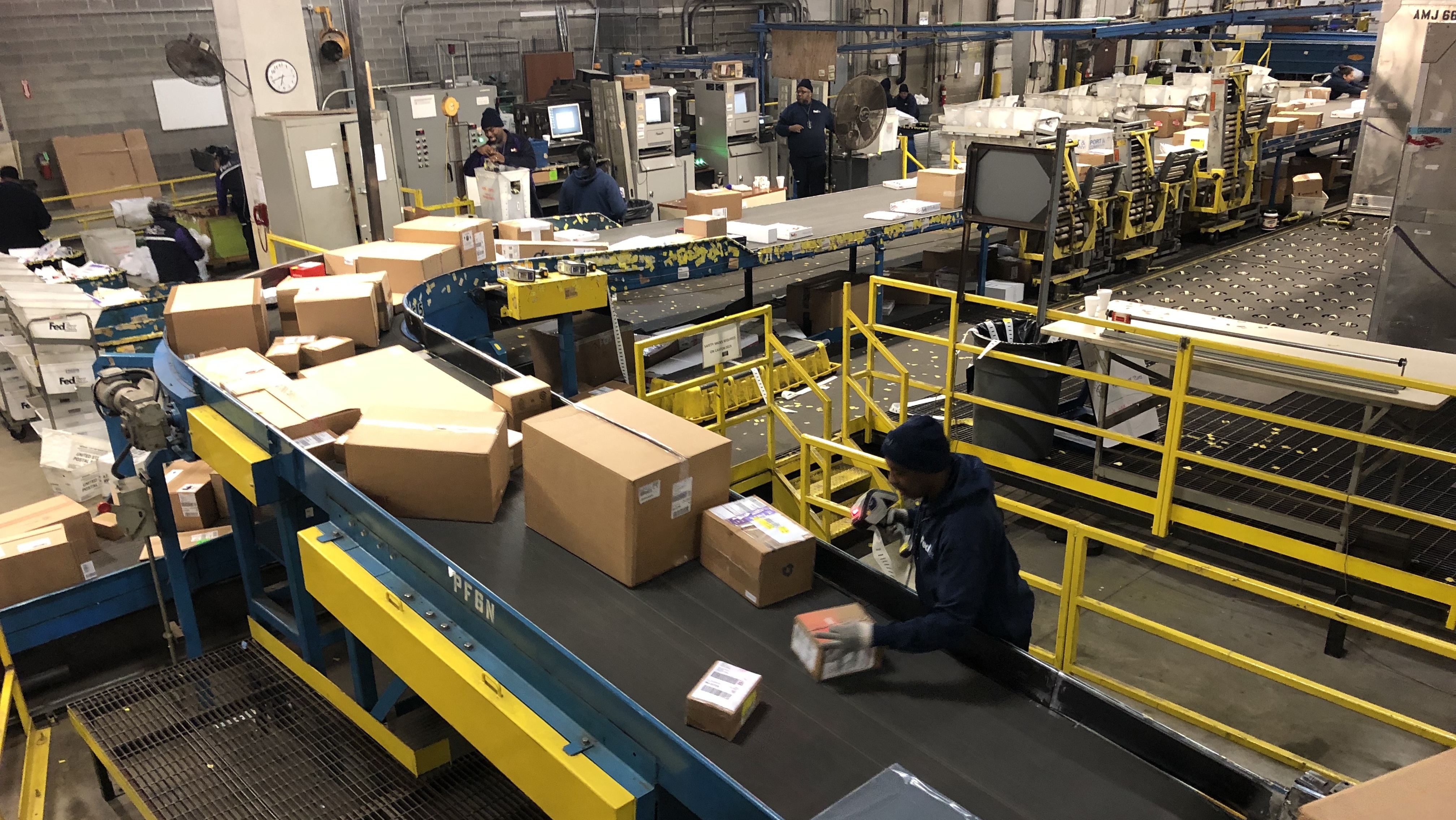 A worker labels packages at a FedEx warehouse in Chicago.