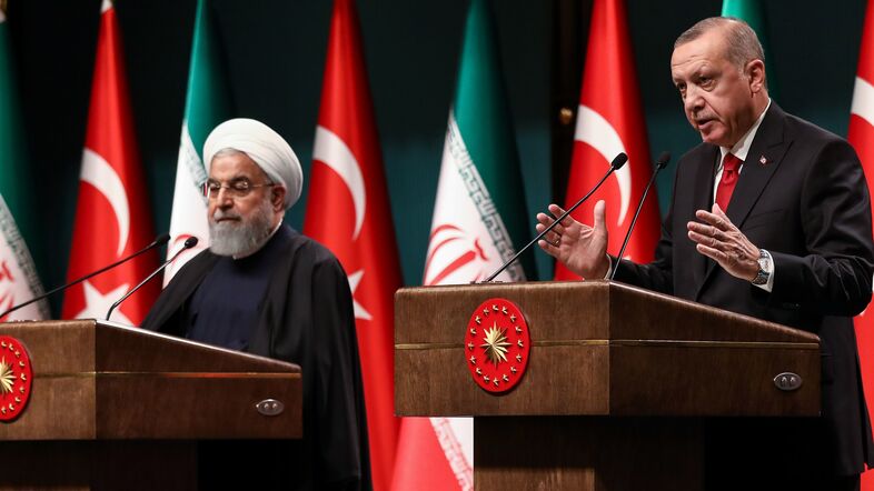 Iranian President Hassan Rouhani (left) and Turkish President Recep Tayyip Erdogan address a joint news conference Thursday in Ankara. The pair of leaders asserted their partnership in Syria after the U.S. announced its withdrawal. (Adem Altan/AFP/Getty Images)