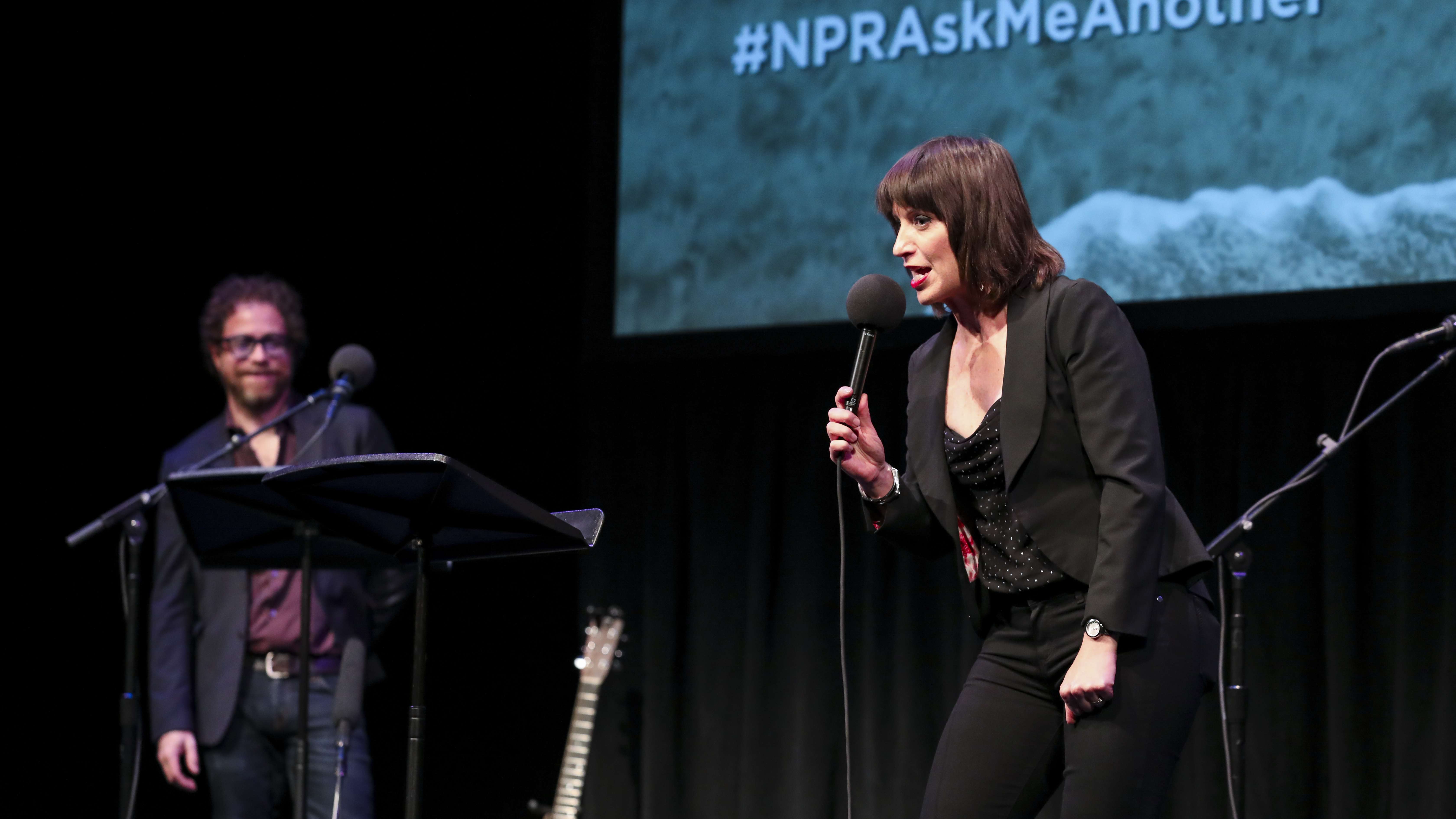 Host Ophira Eisenberg performs stand up on <em>Ask Me Another</em> at the Balboa Theatre in San Diego, California. (NPR)