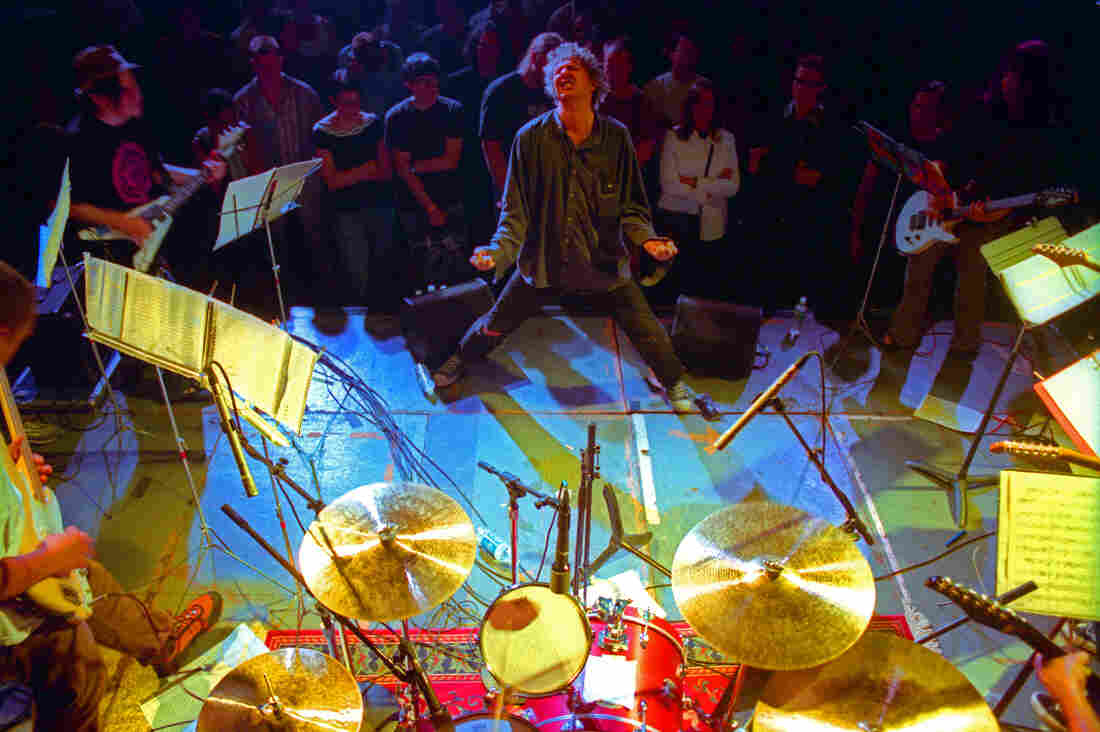 Glenn Branca conducts his ensemble in Brooklyn in 2000.