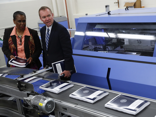 The Government Publishing Office's then-Director Davita Vance-Cooks (left) inspects the production run of President Trump's 2018 fiscal year federal budget with Office of Management and Budget Director Mick Mulvaney in 2017 at the GPO's plant in Washington, D.C.