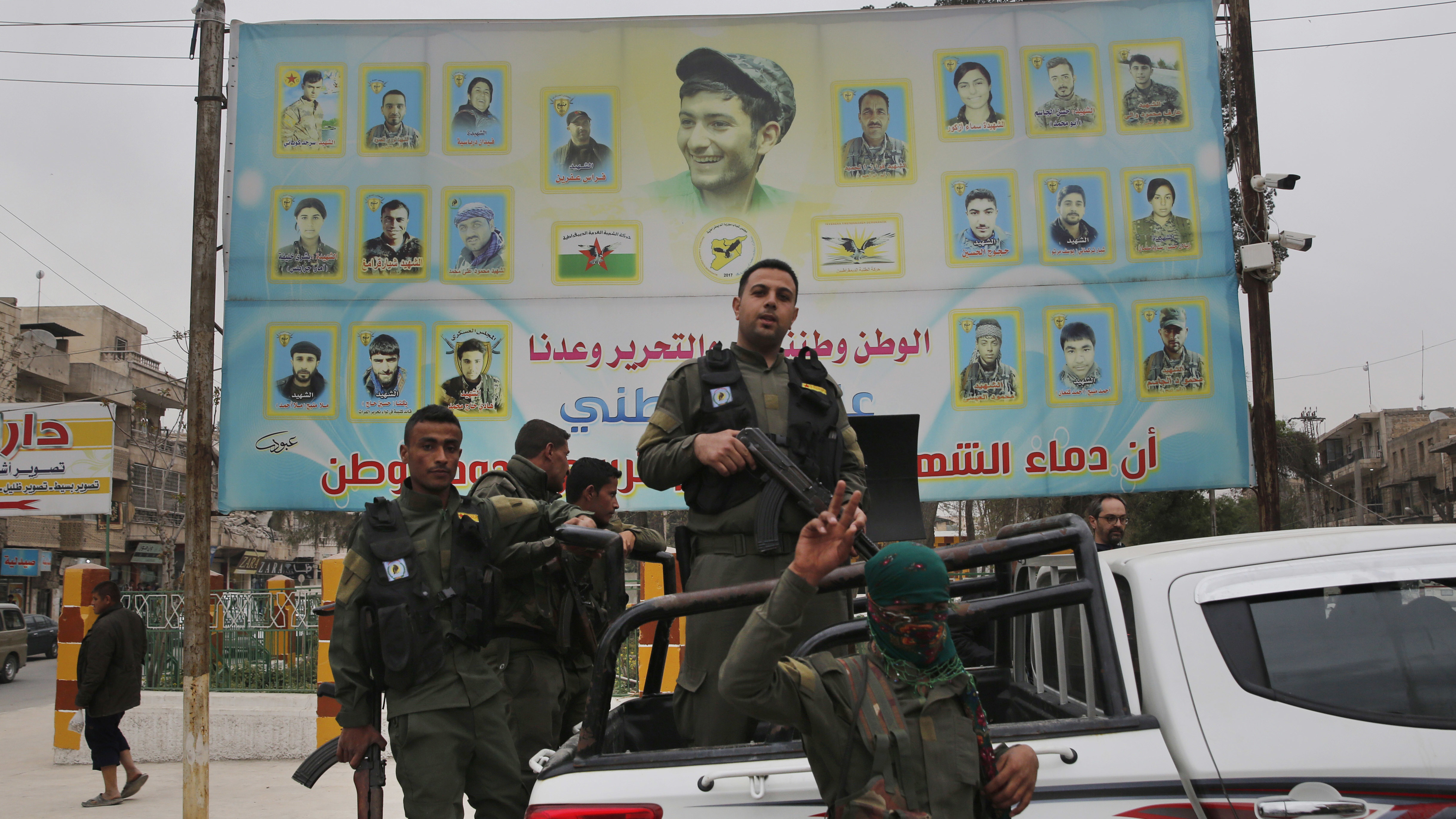 U.S.-backed Kurdish militants seem to be in talks with the Syrian regime to hand over the city of Manbij. Turkey has threatened an offensive against the town if the Kurds remain in control. Here, members of the Kurdish internal security force are seen in a photo from March.