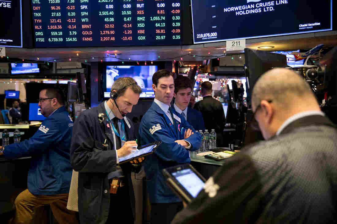 Traders work on the floor of the New York Stock Exchange on Friday.