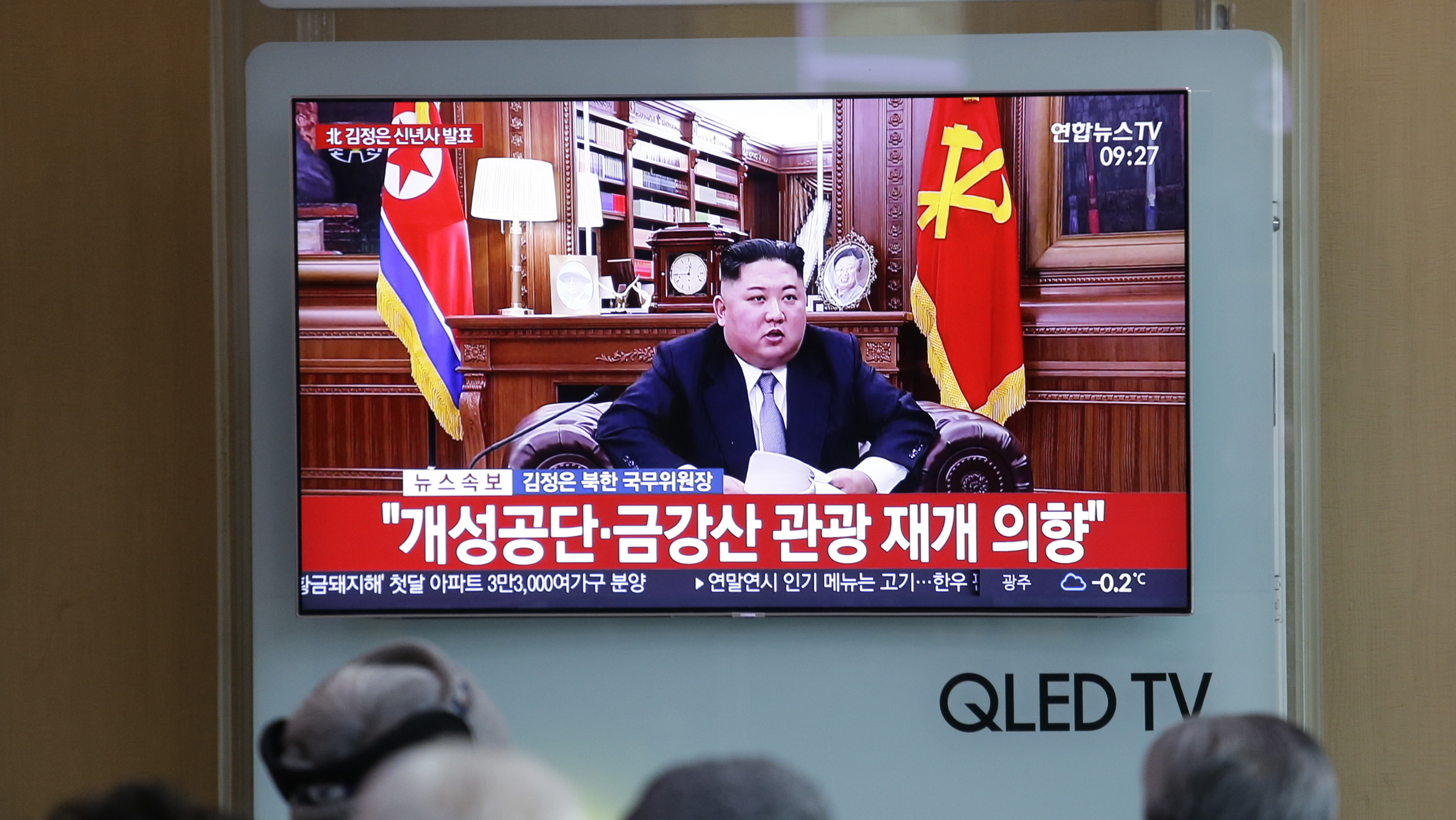 People at a railway station in Seoul, South Korea, watch a TV screen showing North Korean leader Kim Jong Un delivering his New Year