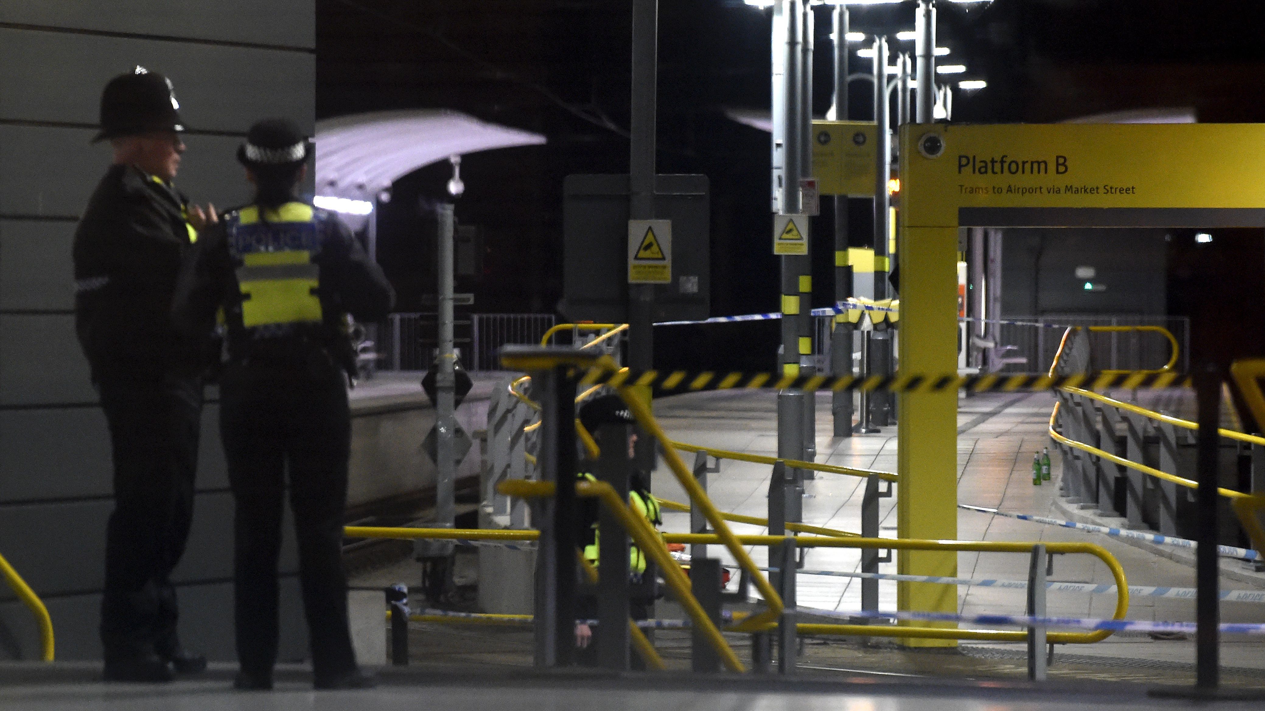 Police stand near a cordon at Manchester Victoria Station on Tuesday after an attack on New Year