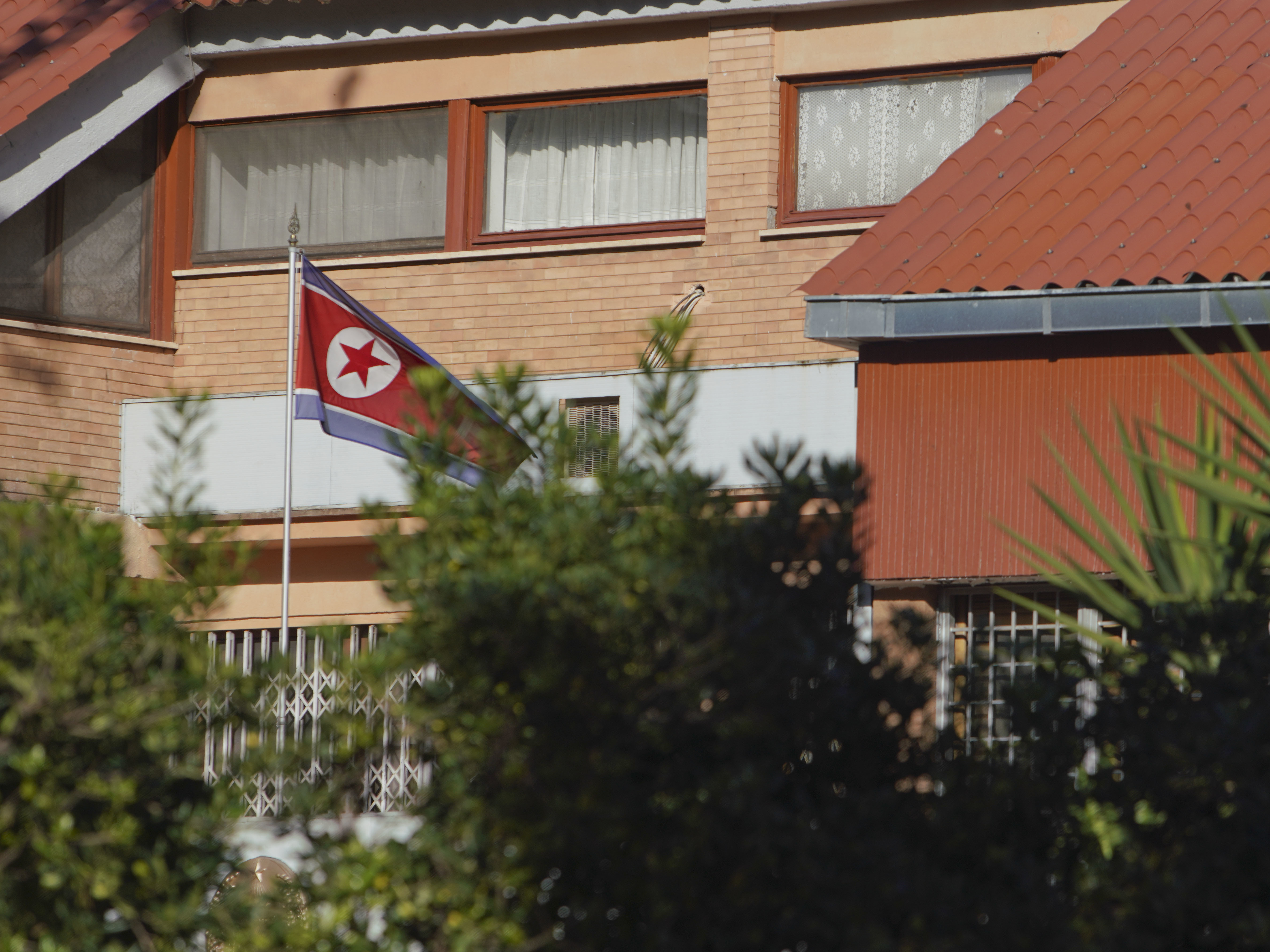The flag of North Korea waves inside the compound of the North Korean embassy in Rome. North Korea's acting ambassador to Italy, Jo Song Gil, went into hiding with his wife in November, according to South Korea's National Intelligence Service.