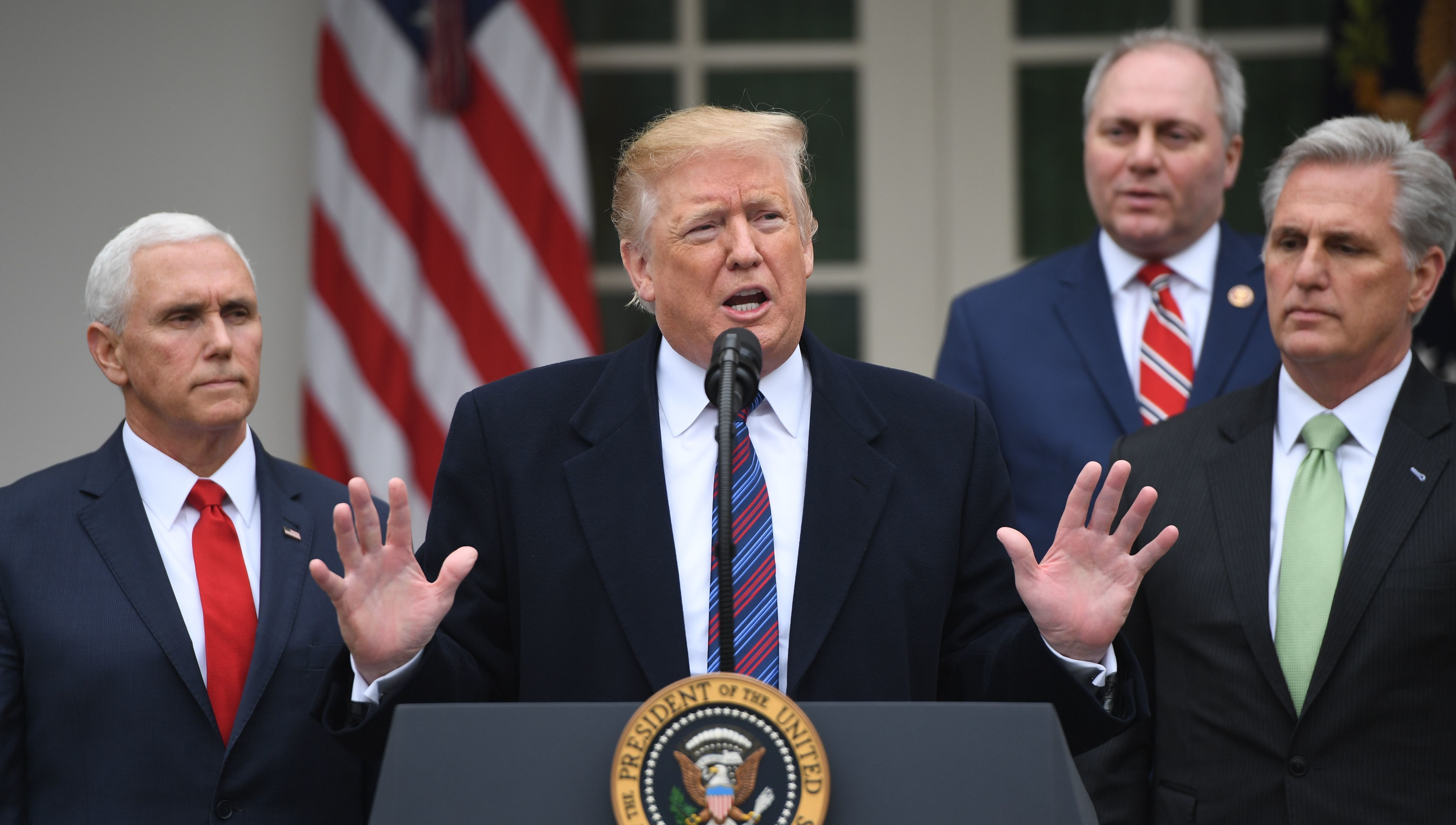 President Trump, with (from left) Vice President Pence, House Minority Whip Steve Scalise and House Minority Leader Kevin McCarthy, addresses reporters in the Rose Garden of the White House about the government shutdown on Friday. (AFP/Getty Images)