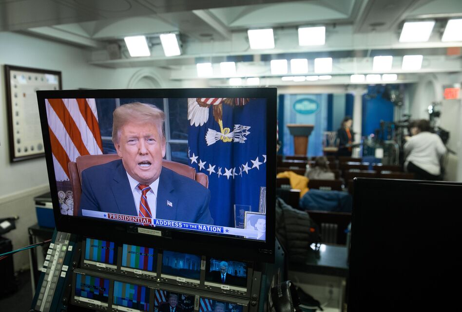 President Trump appears on a monitor in the Press Briefing Room of the White House on Tuesday. (Saul Loeb/AFP/Getty Images)