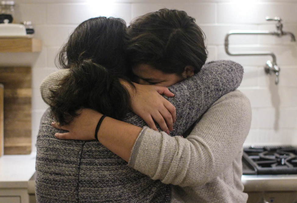 Maria Rivas and her 15-year-old daughter, Emily, embrace after their StoryCorps interview last month. (StoryCorps)