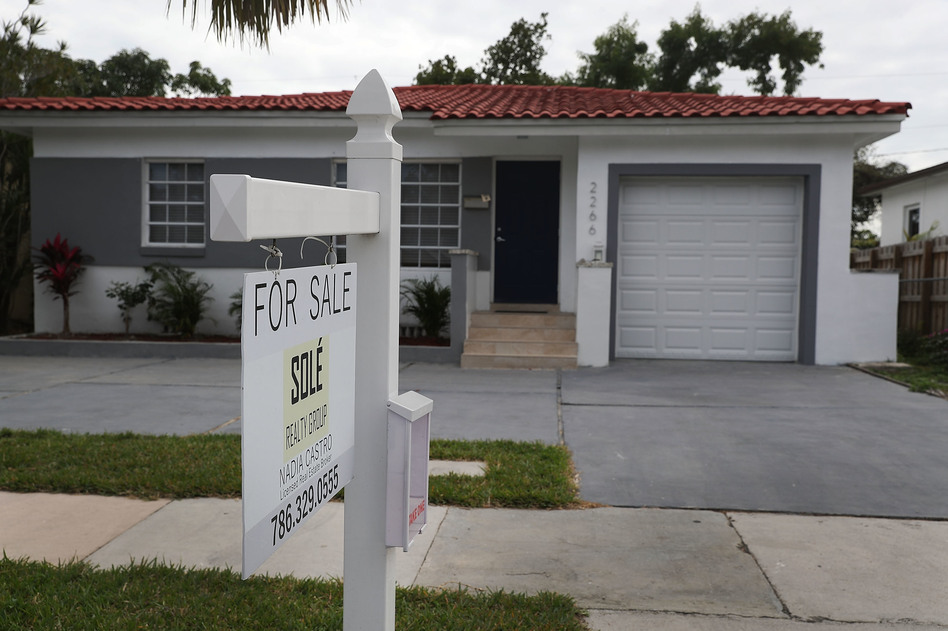 A "for sale" sign is seen in front of a home in Miami on Jan. 24, 2018. The partial shutdown of the federal government is causing some financial problems for furloughed workers who can't refinance their mortgages or buy homes because lenders can't verify their income. (Joe Raedle/Getty Images)