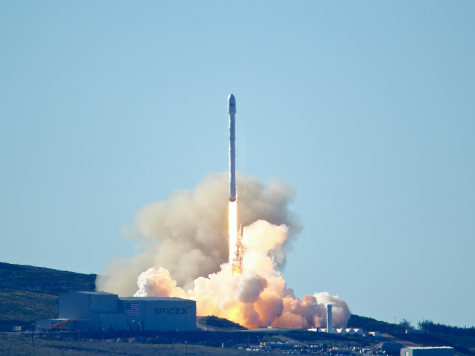 Space-X's Falcon 9 rocket with 10 satellites launches at Vandenberg Air Force Base, Calif., in 2017. The company says it will lay off 10 percent of its workforce.
