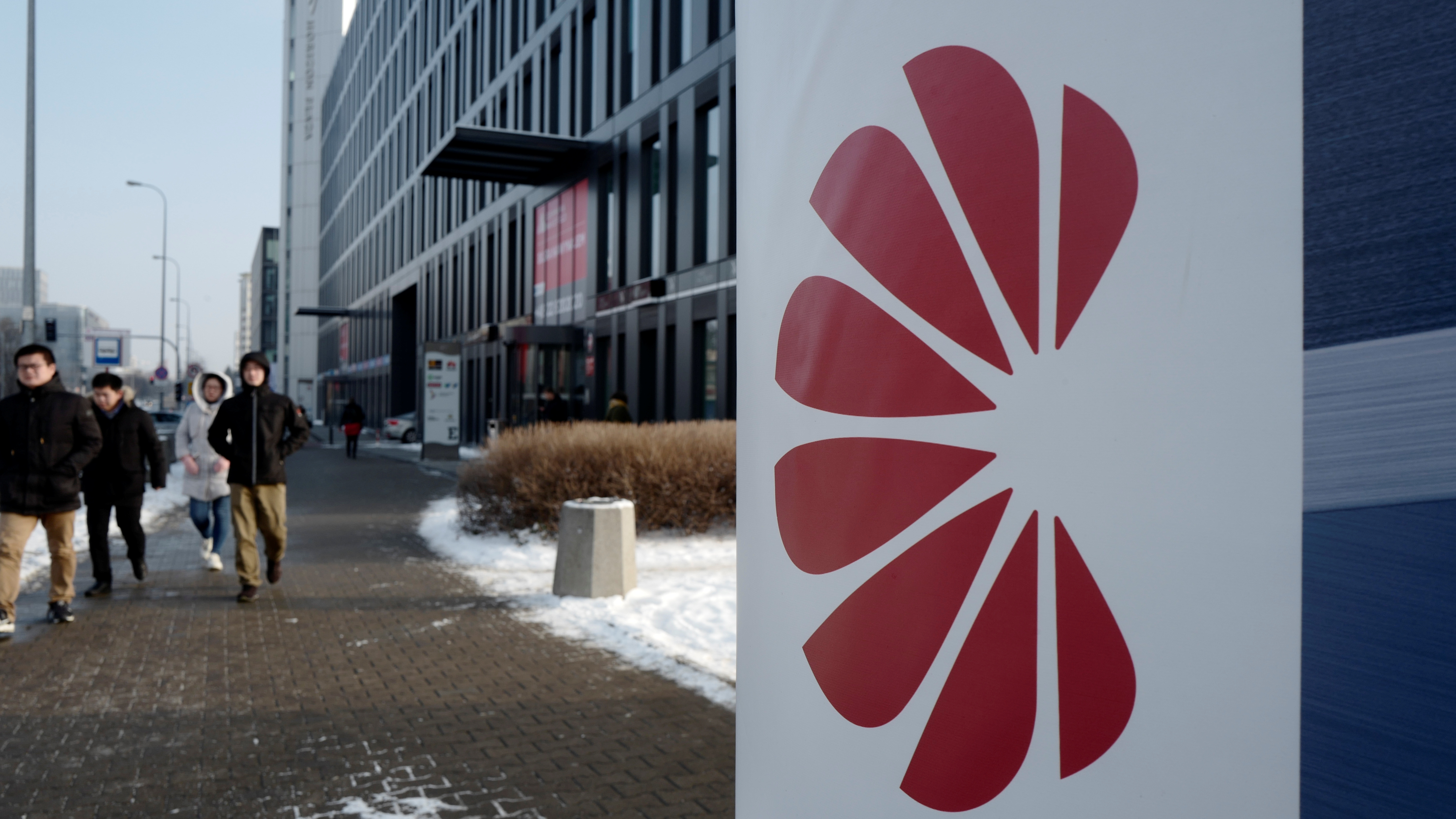 Poland's Internal Security Agency accuses Huawei's sales director in Poland of spying on behalf of China, arresting the Chinese citizen along with one other man. Here, people walk by Huawei's offices in Warsaw on Friday. (Reuters)