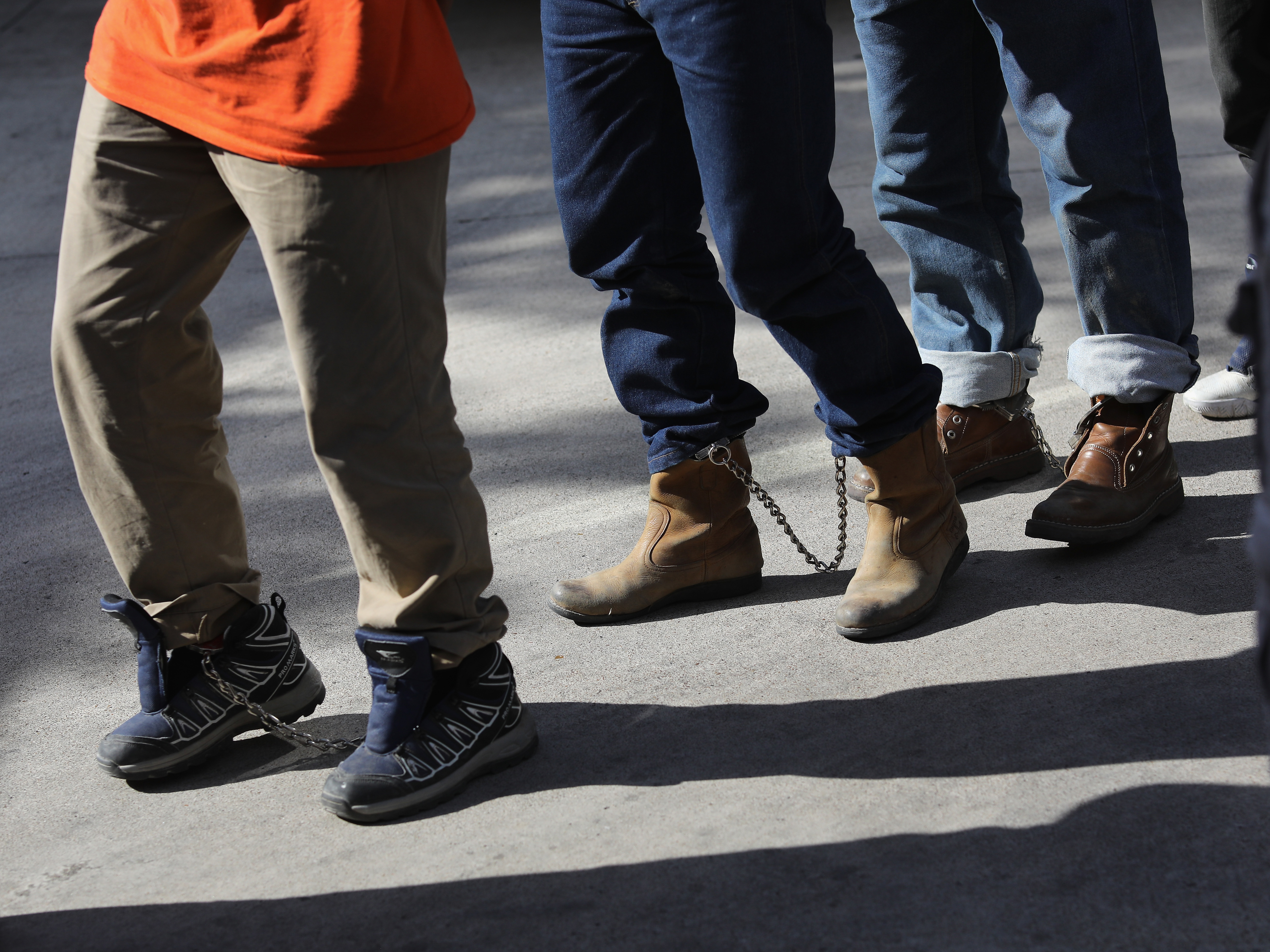 Unauthorized immigrants leave a court in shackles in McAllen, Texas. More than 40,000 immigration court hearings have been canceled since the government shut down. (Getty Images)
