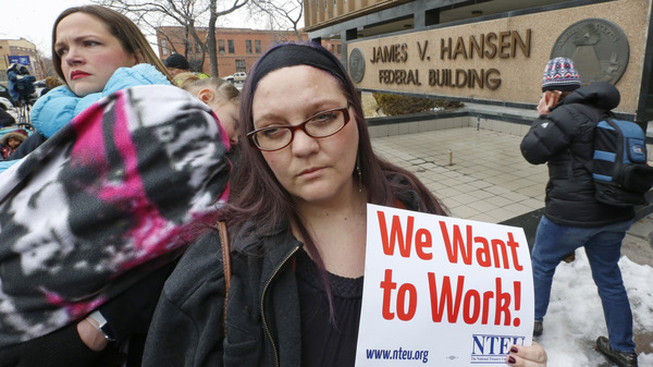 IRS worker Christine Helquist joins a federal workers protest rally against the government shutdown outside the federal building in Ogden, Utah.