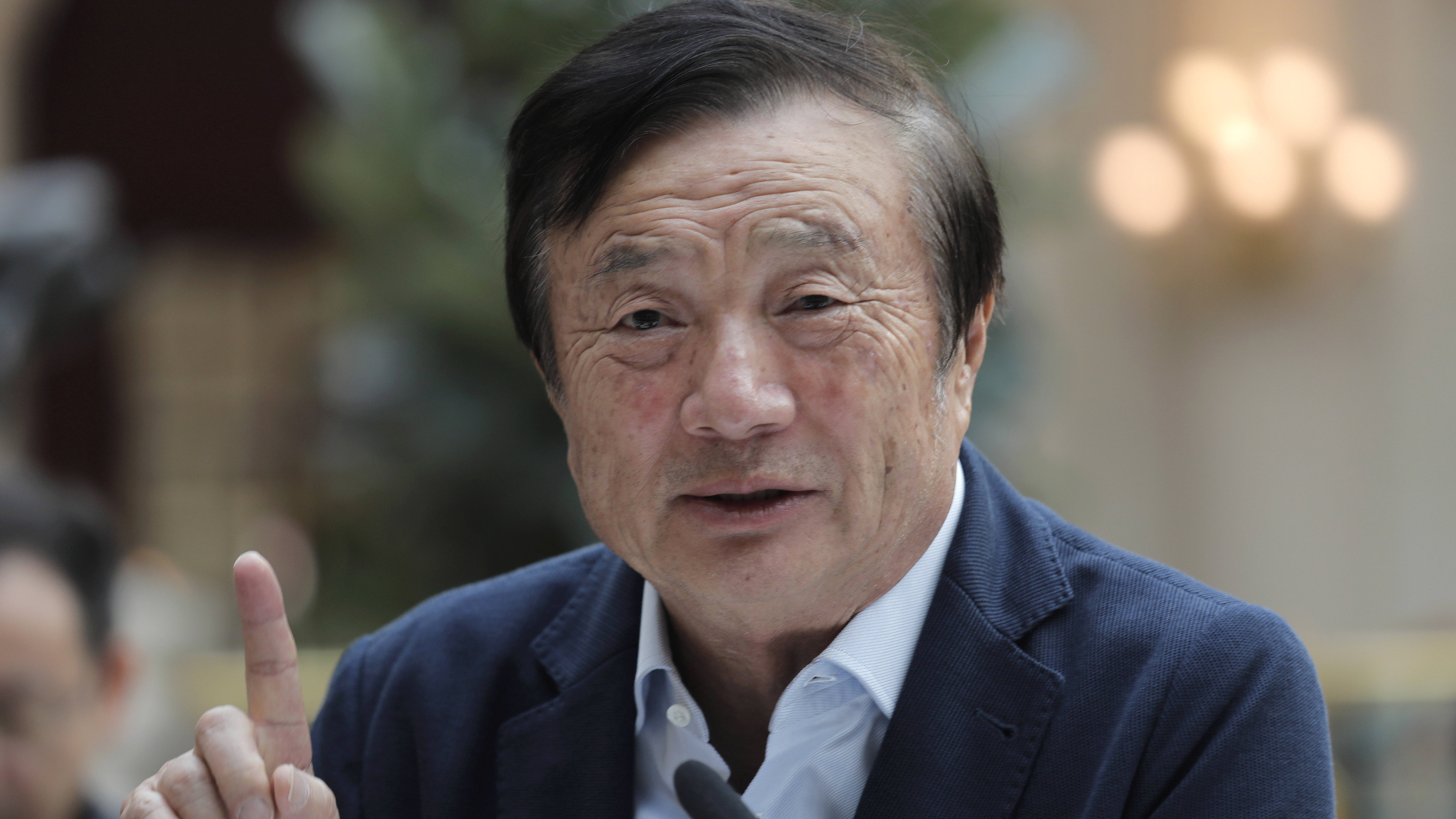 Ren Zhengfei, founder and CEO of Huawei, speaks with media Tuesday in Shenzhen, China.