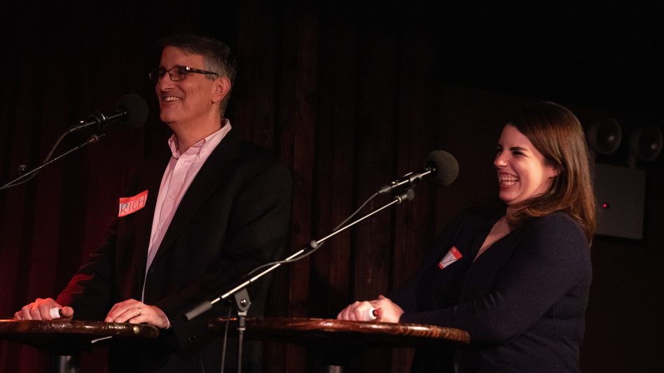 Contestants Rich Fisler and Emily Mongeau play trivia games on <em>Ask Me Another</em> at the Bell House in Brooklyn, New York.
