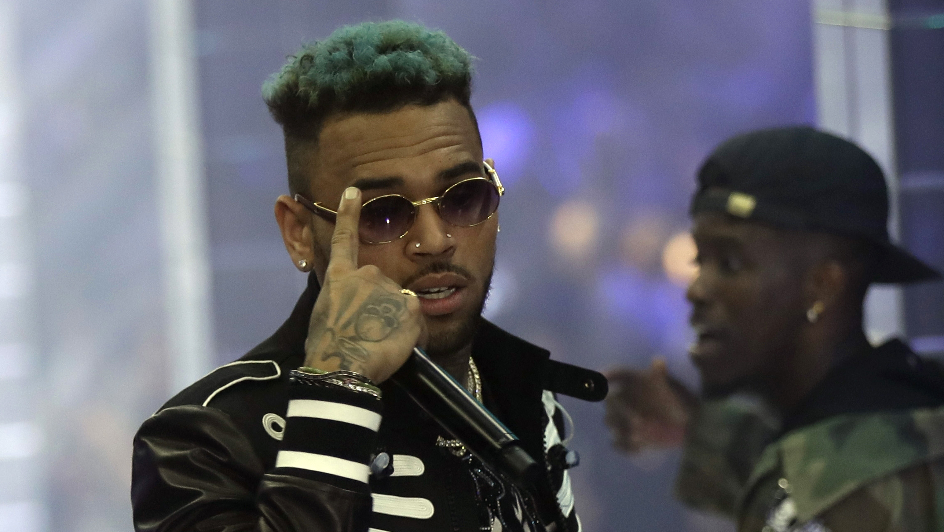 Chris Brown performs during Fashion Week last fall in Milan, Italy. The Paris prosecutor says the singer and two other individuals were arrested. Brown has been accused of rape and narcotics possession.