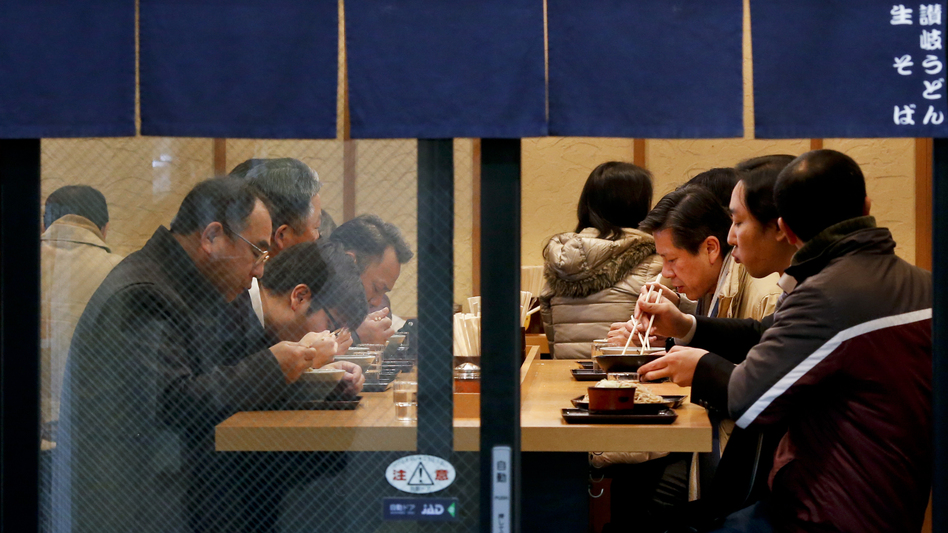People slurp soup and pluck noodles at a soba and udon restaurant in Tokyo in February 2016.