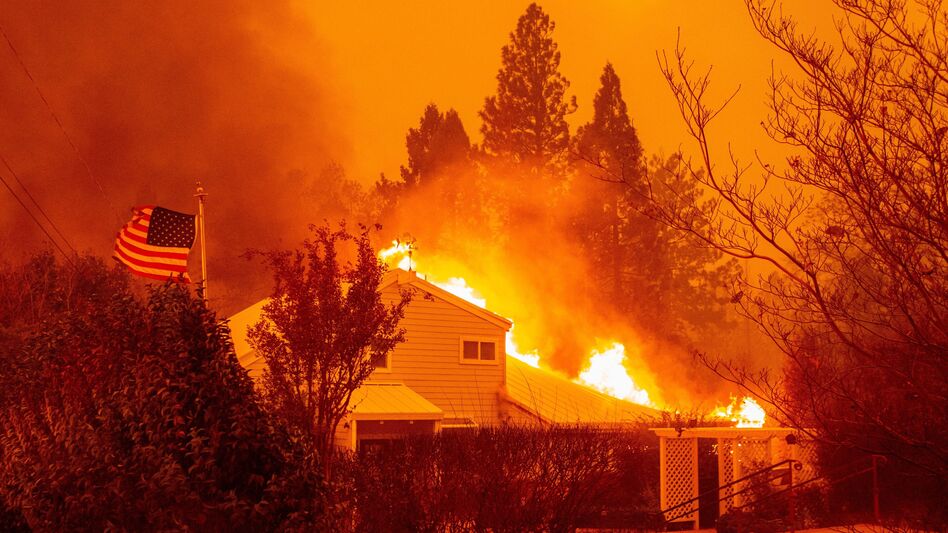 A home burns during the Camp Fire in Paradise, Calif., in November 2018. It was one of several fires often discussed in terms of the changing climate. A new survey shows a jump in the number of Americans who are "very worried" about global warming.
