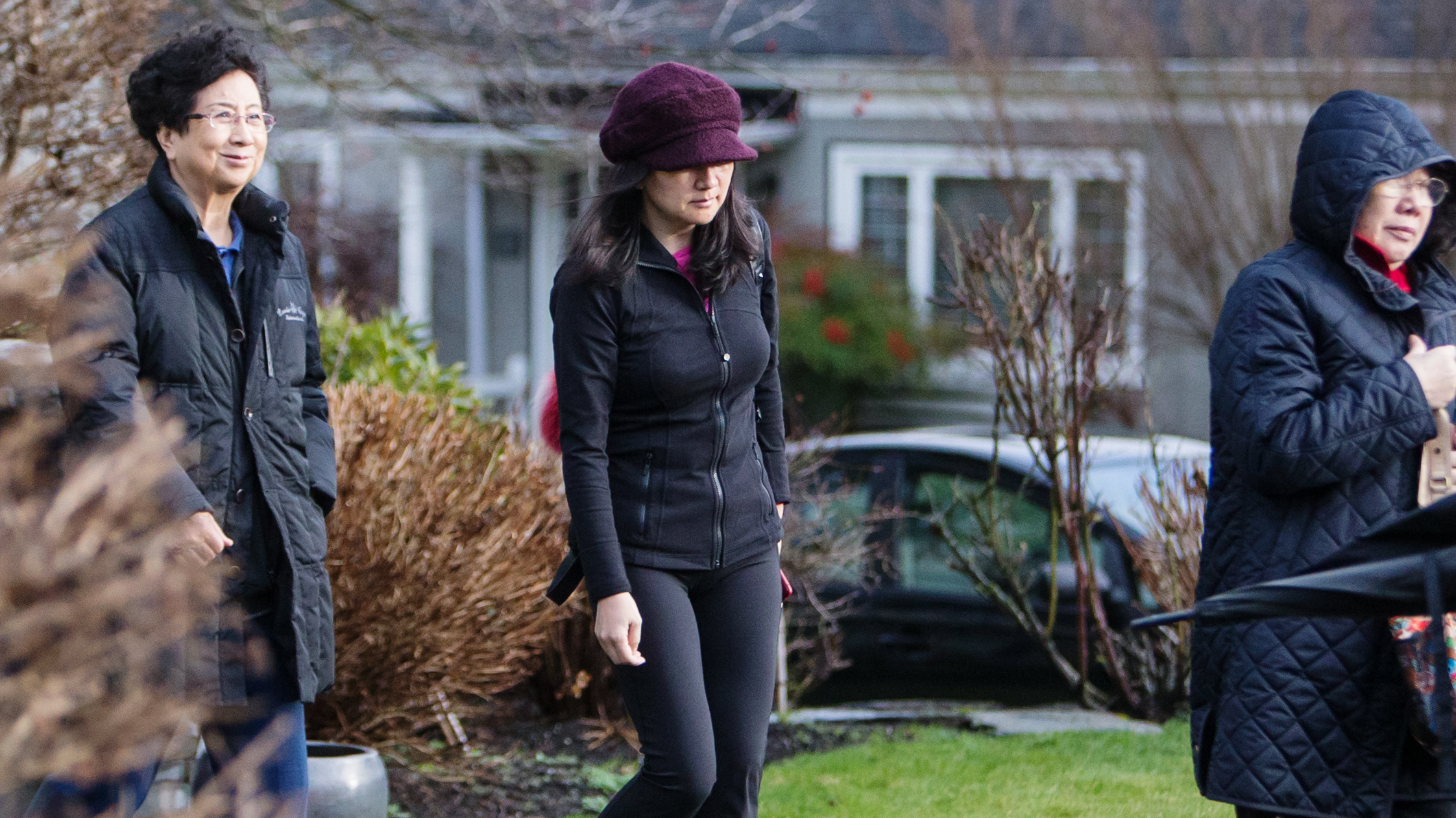 The U.S. faces a Jan. 30 deadline to request extradition from Canada for Huawei executive Meng Wanzhou (center) seen here leaving her home while out on bail in Vancouver. (Bloomberg via Getty Images)