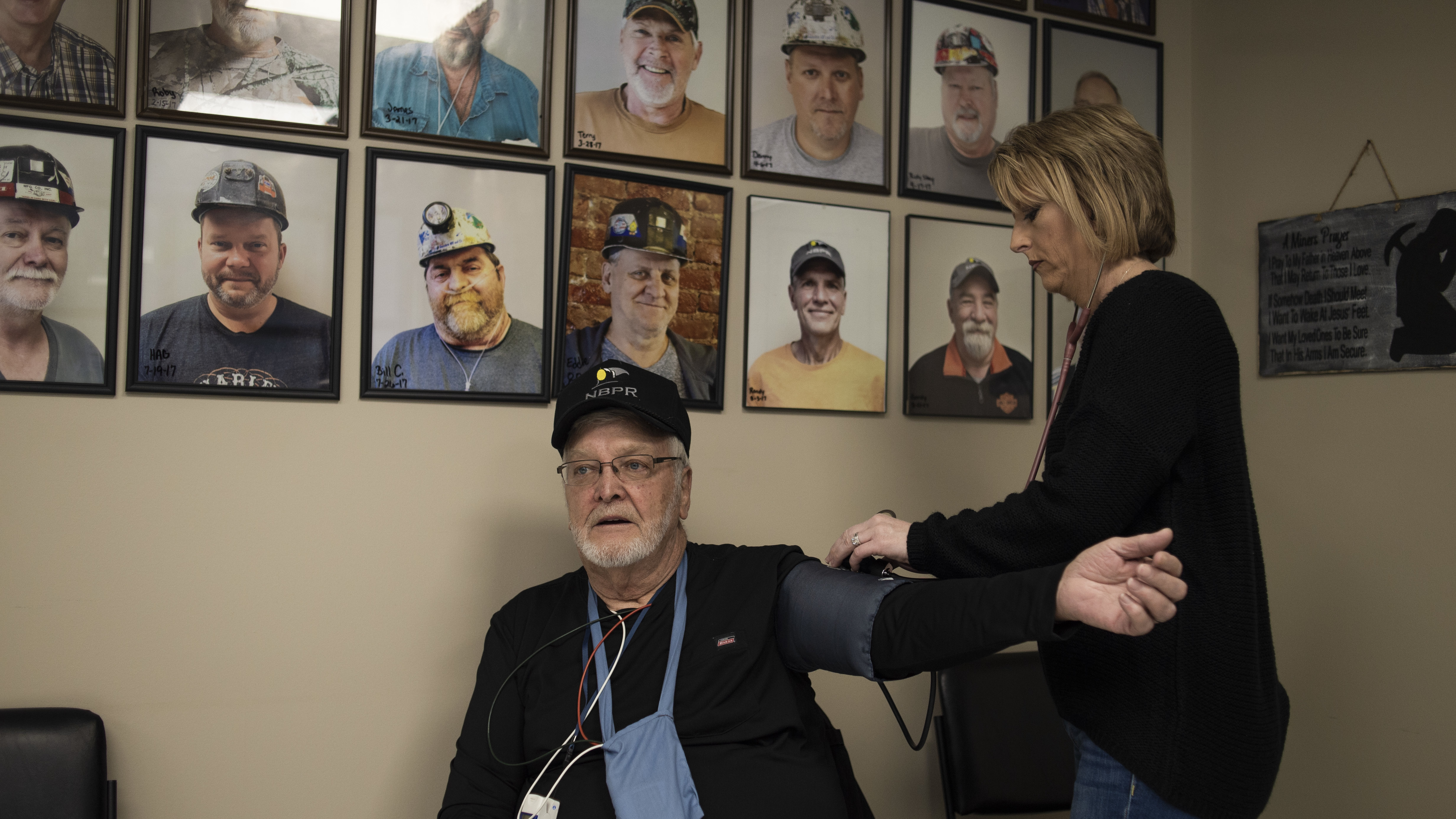 Respiratory therapist Deena Neace checks James Muncy's blood pressure and pulse during a therapy session at the New Beginnings Pulmonary Rehab Clinic in South Williamson, Ky. Muncy is one of thousands of coal miners across Appalachia who are dying of advanced black lung. (Matthew Hatcher for NPR)