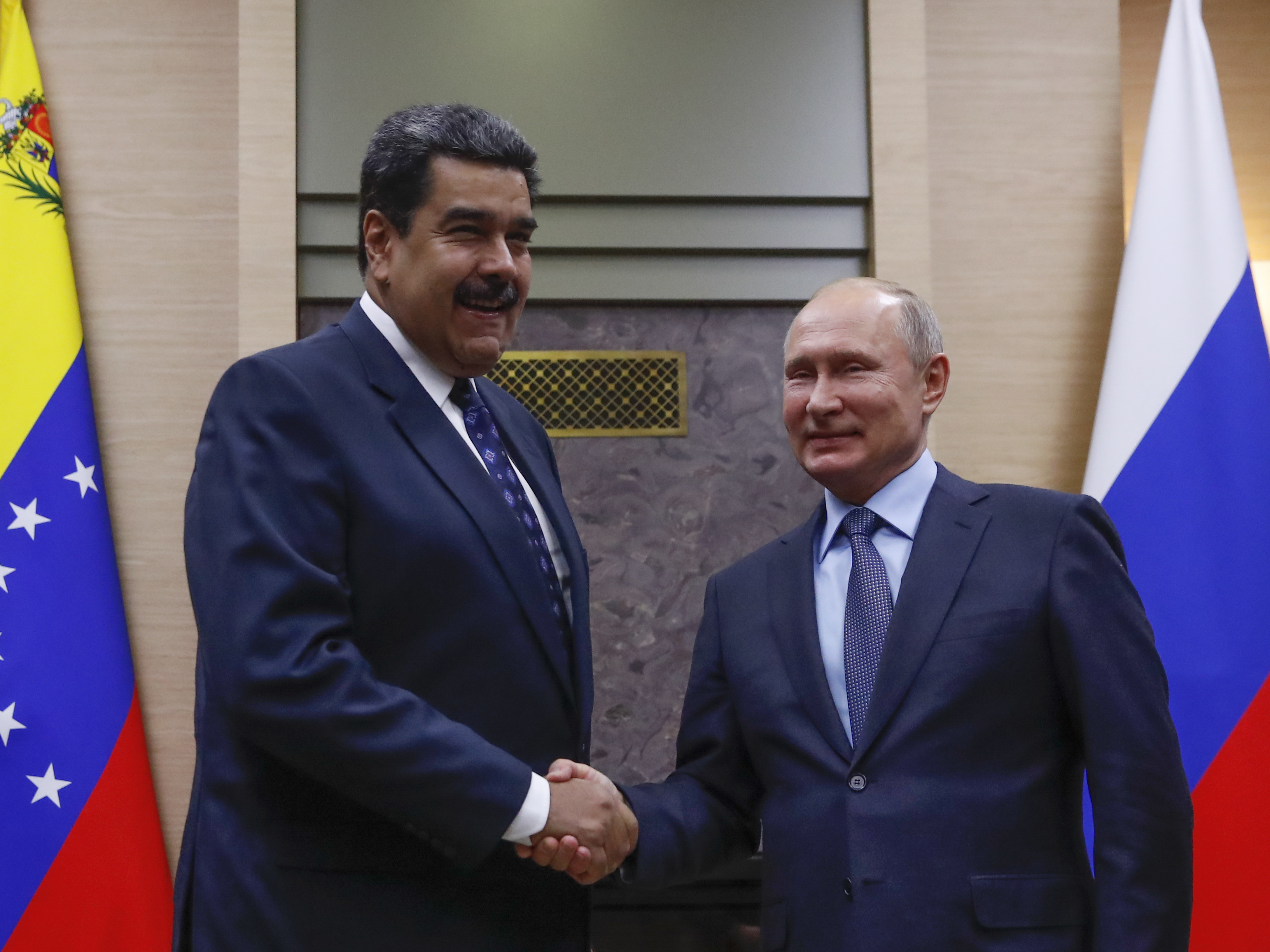Russian President Vladimir Putin shakes hands with Venezuela's Nicolás Maduro during a meeting outside Moscow on Dec. 5. (AFP/Getty Images)