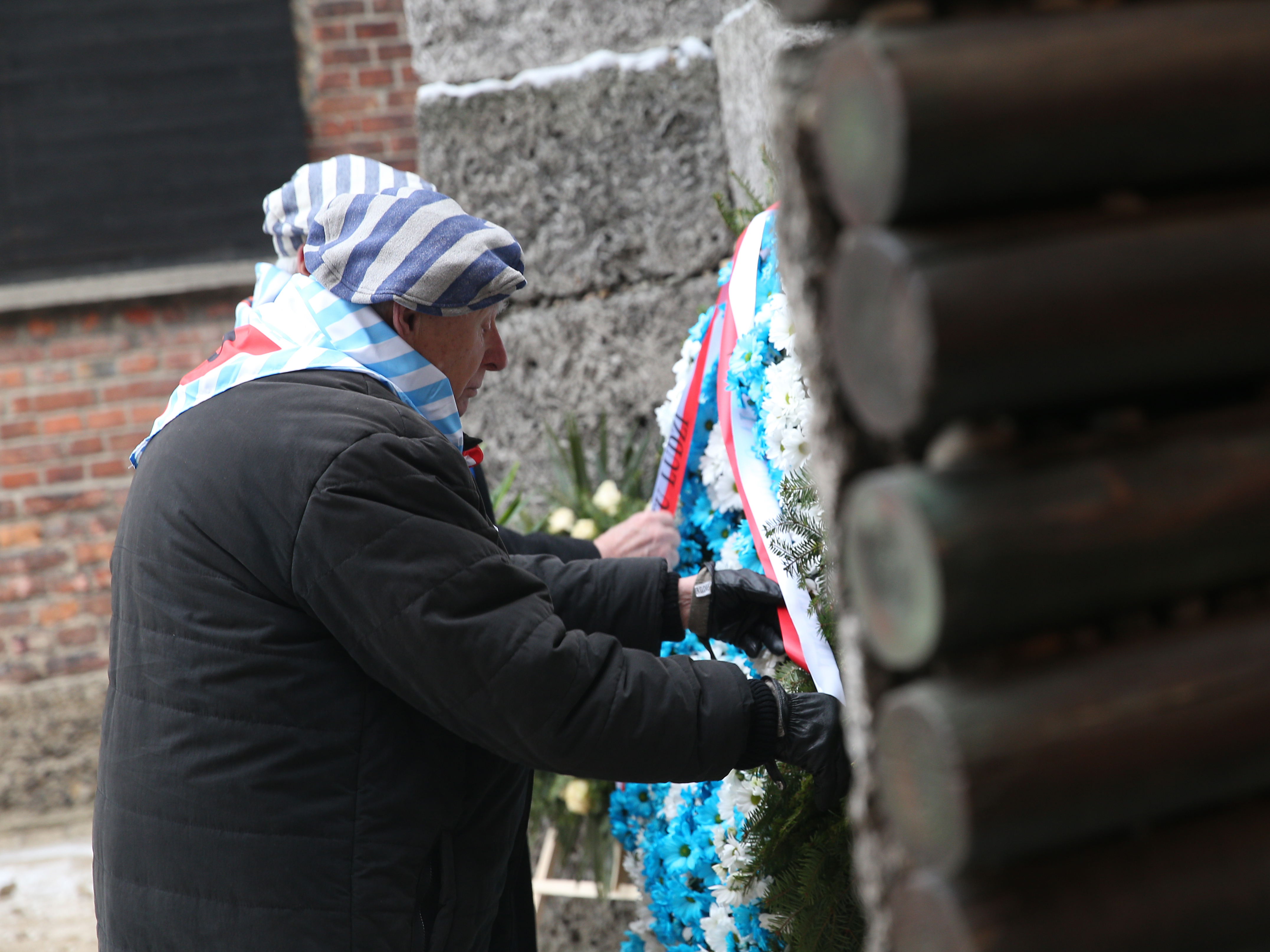 A former prisoner pays tribute during the 74th anniversary of the liberation of Auschwitz.