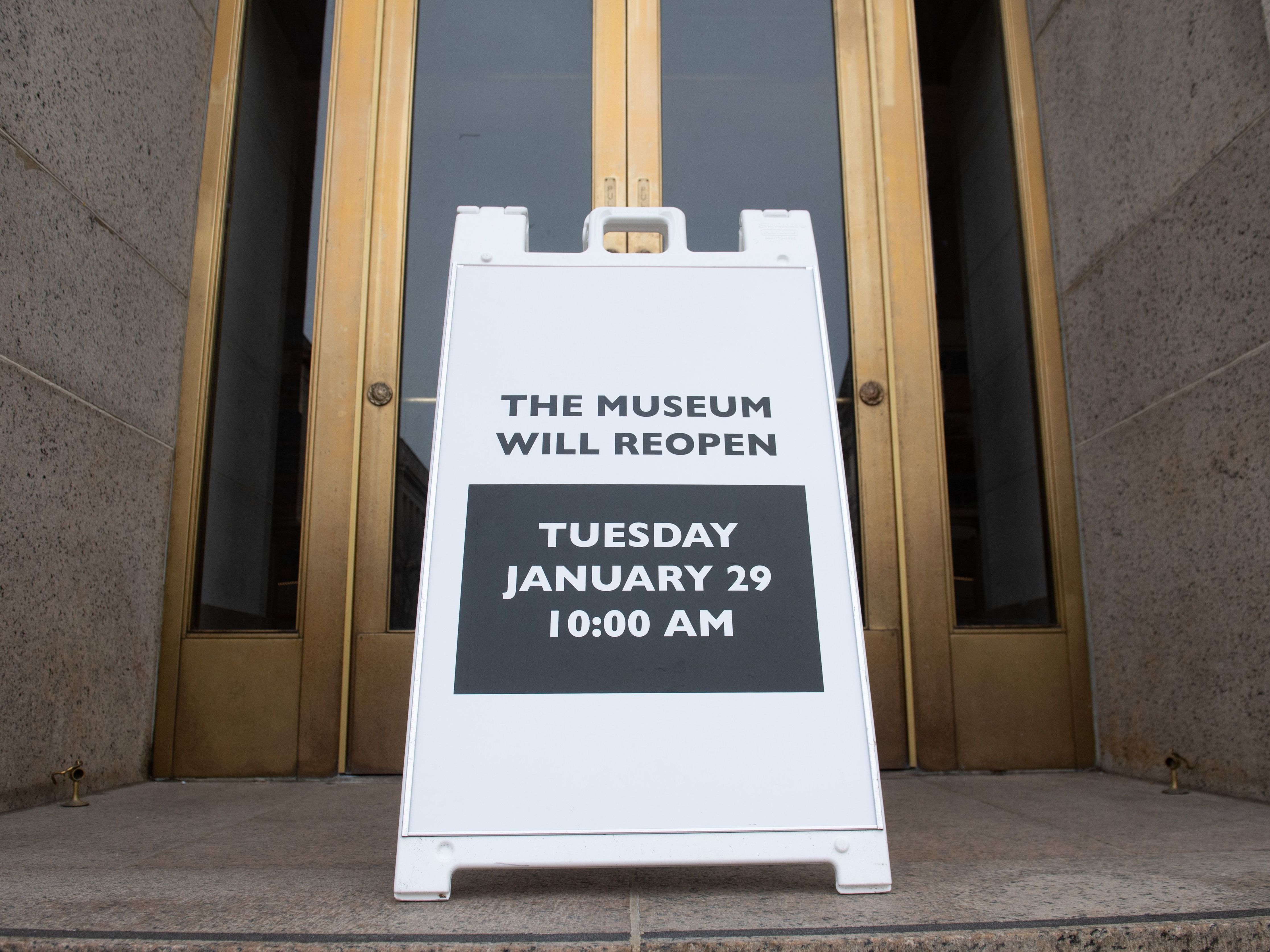 A sign at the entrance of the Smithsonian National Museum of Natural History in Washington, D.C., says the museum will reopen Tuesday. The shutdown reduced federal spending by $18 billion, although most of that will be recouped now that the government has reopened, according to a new report. (AFP/Getty Images)