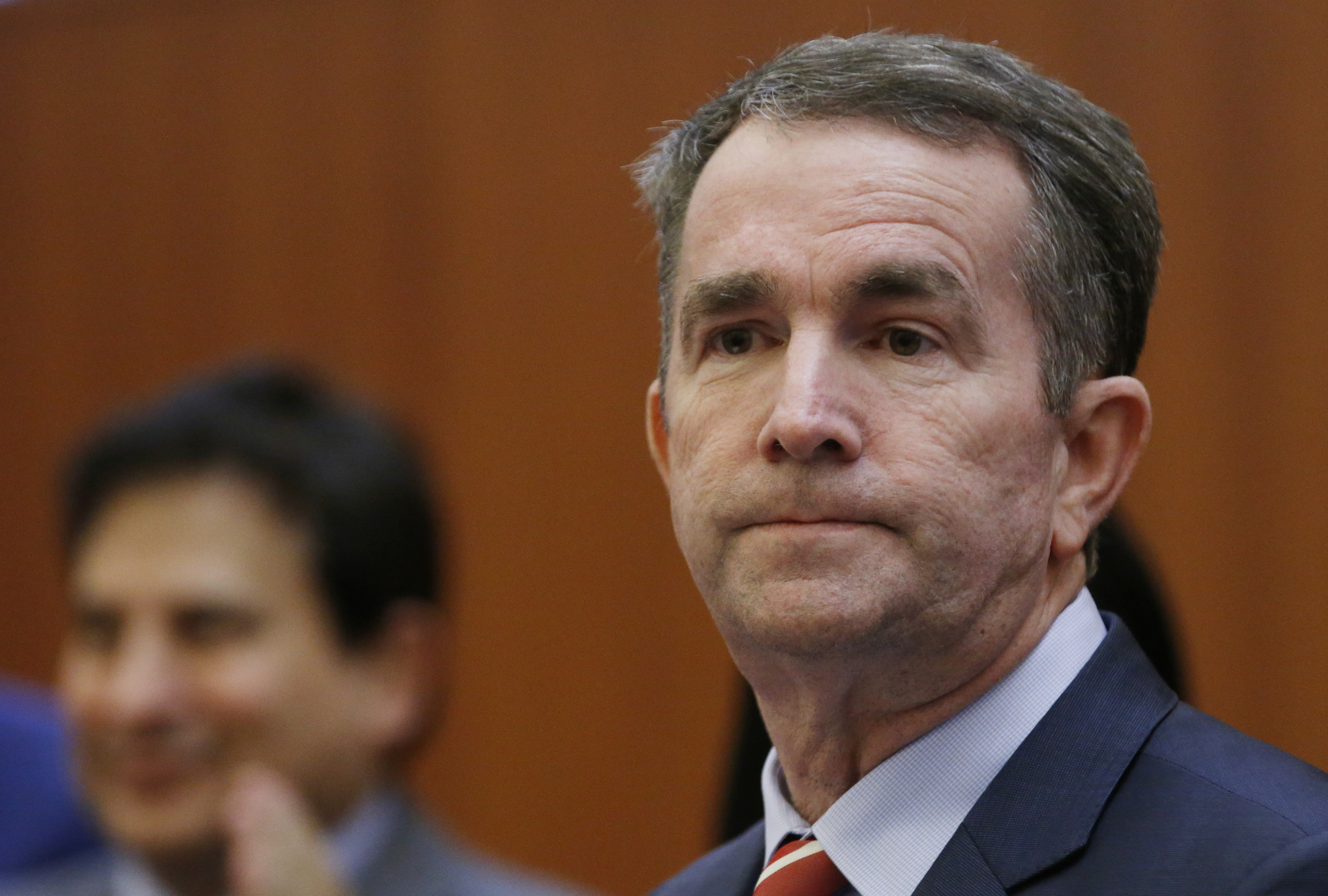Virginia Gov. Ralph Northam, pictured preparing to address a news conference on Thursday, issued an apology for a racist photo on his medical school yearbook page.