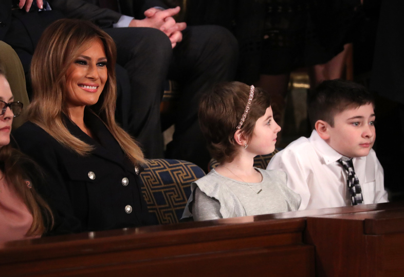 The frst lady sits with guests Grace Eline (center), a cancer survivor, and Joshua Trump (right), a Delaware student who has been bullied because of his last name, during Tuesday's State of the Union address. (Jonathan Ernst/Reuters)