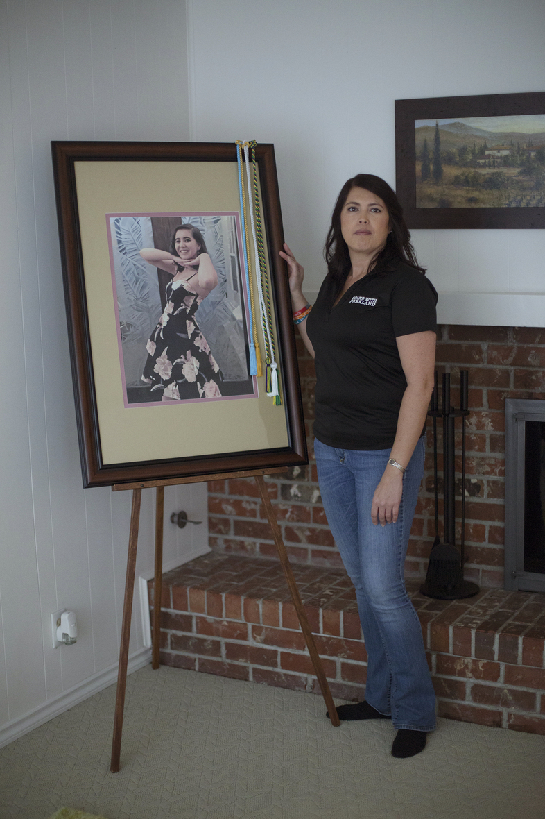 One year after Carmen's death, April Schentrup stands beside a photograph of her daughter that was used during her funeral but now rests in the family's new home. April, who worked as an elementary school principal near Parkland, Fla., now advocates for gun reform. (Alyse Young for NPR)